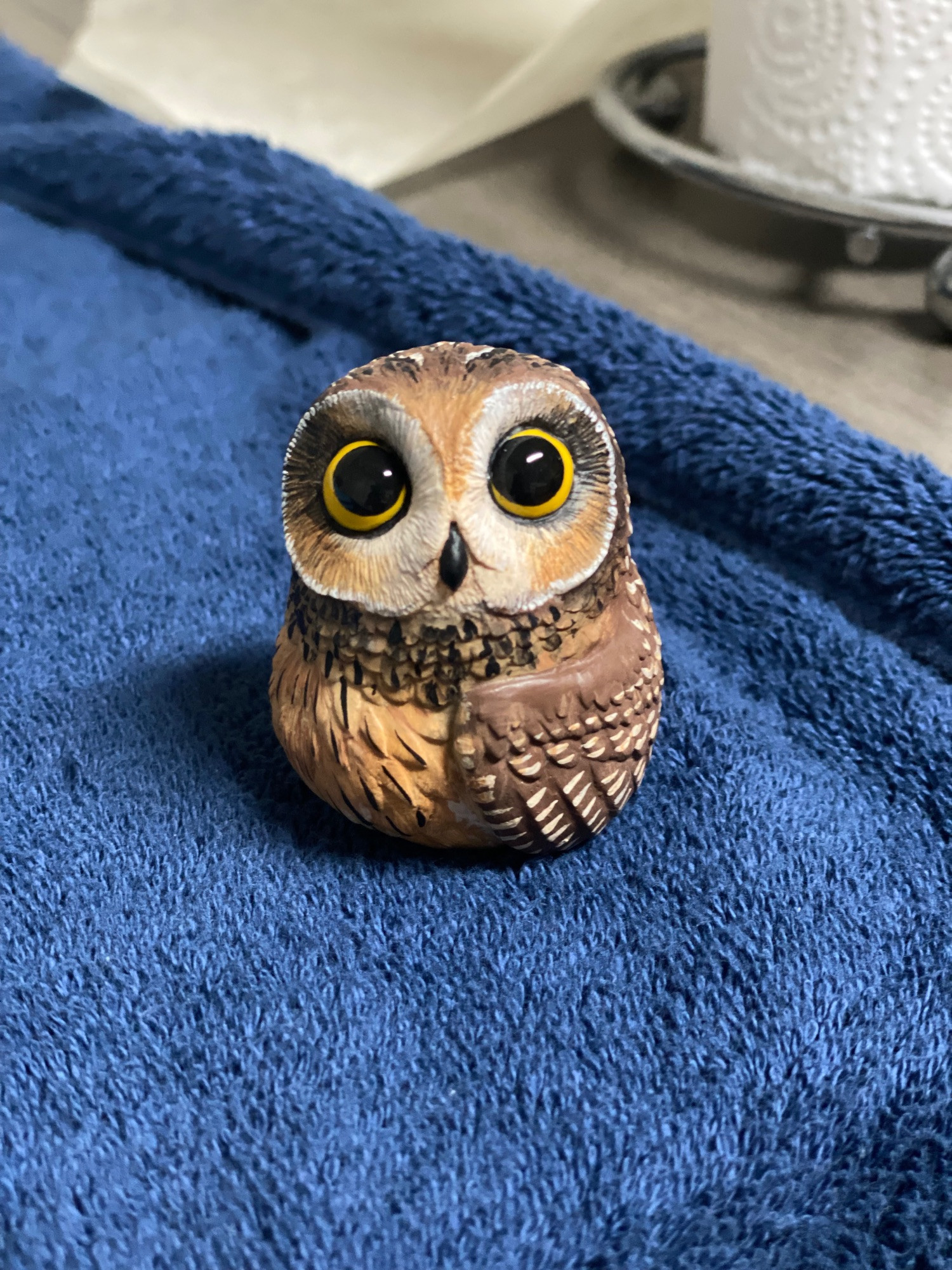 An owl sculpture/cast, painted to resemble a short-eared owl.