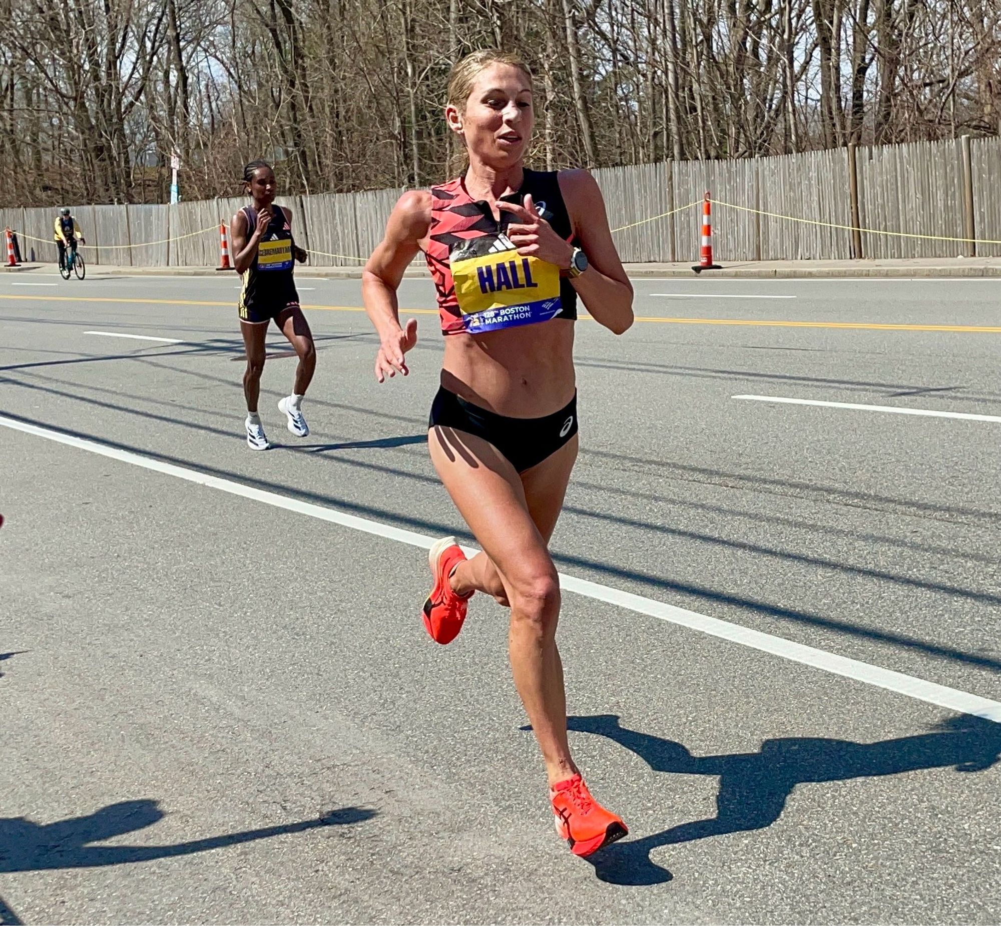 A photo of Sara Hall running in the Boston Marathon just before mile 17.