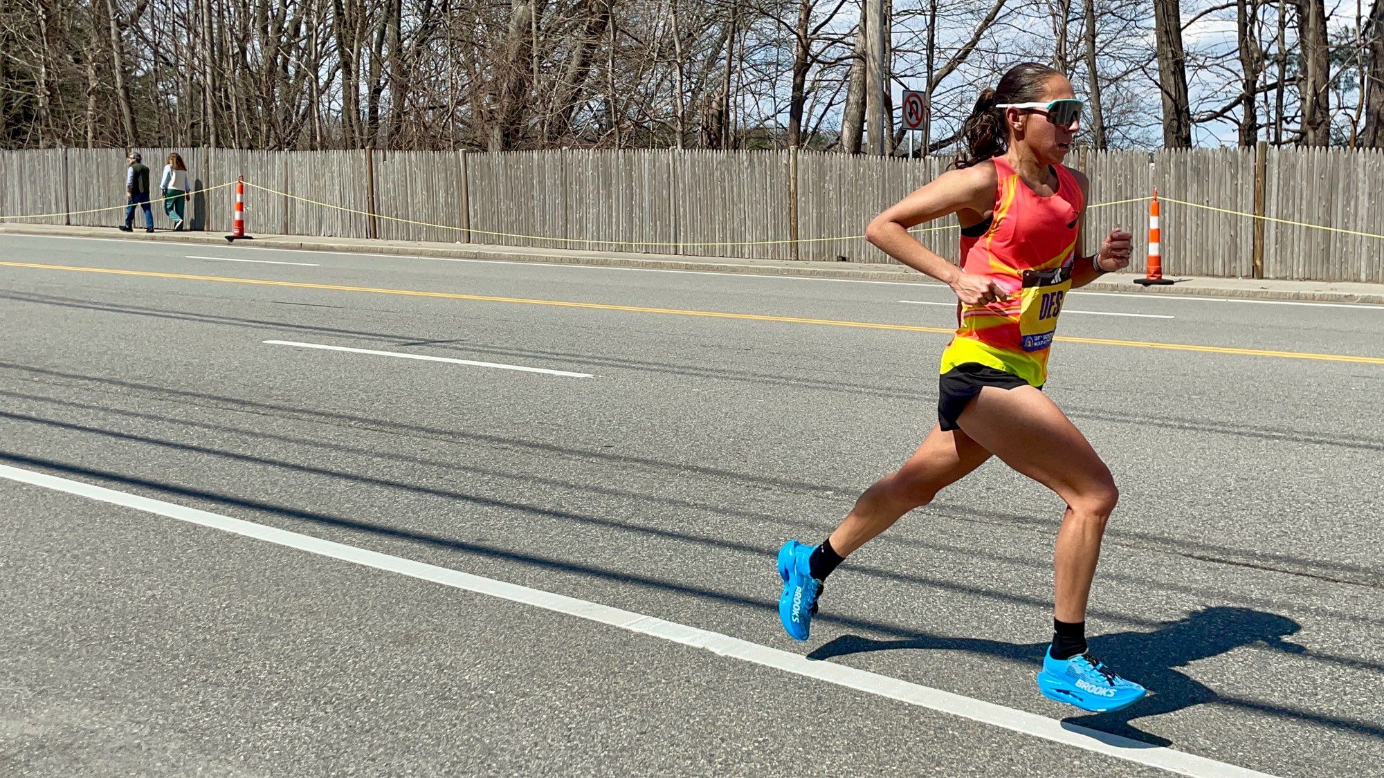 A photo of Des Linden running in the Boston Marathon just before mile17.