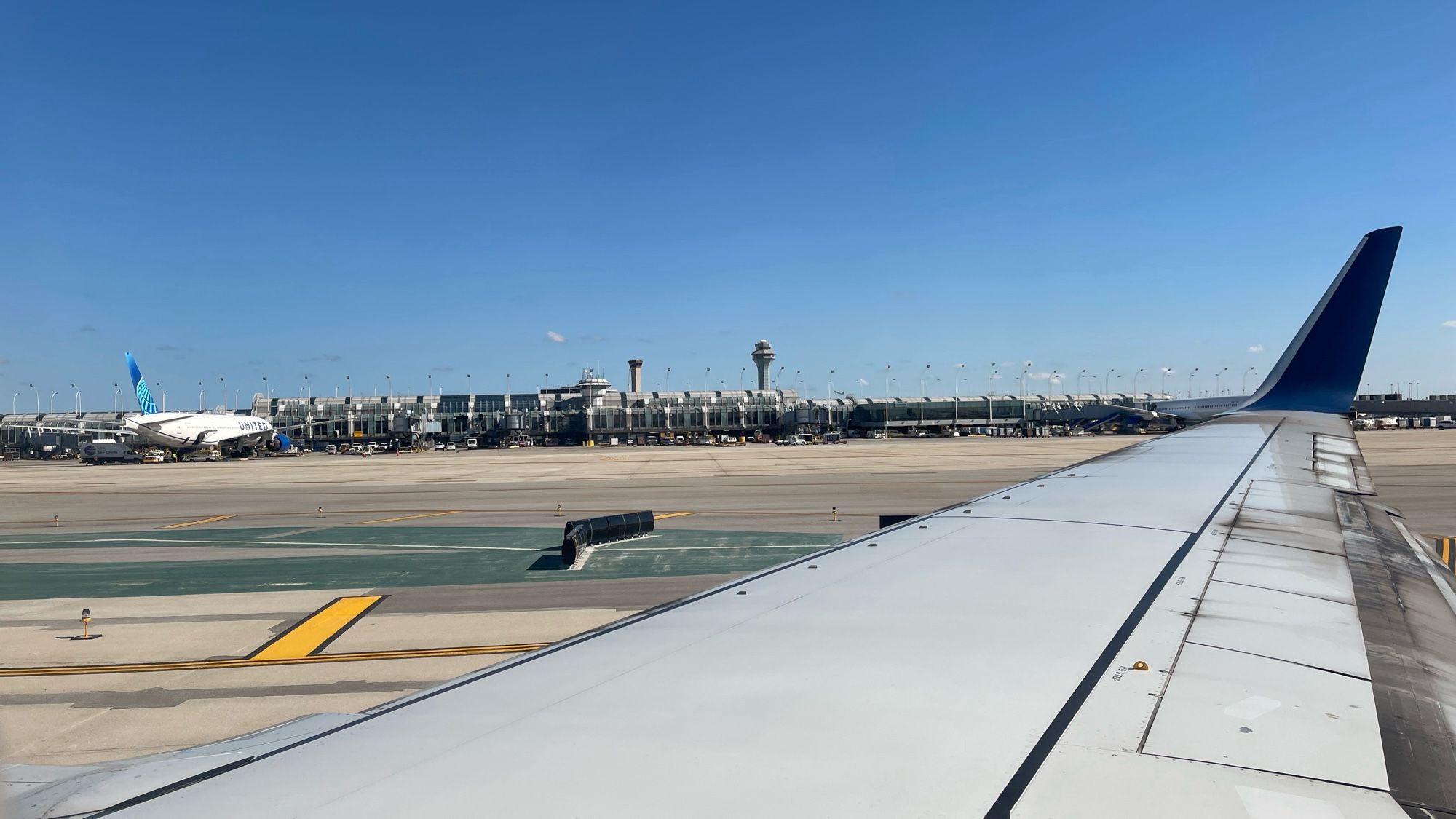 Taking from the window seat of a plane with Chicago O’Hare airport in the background