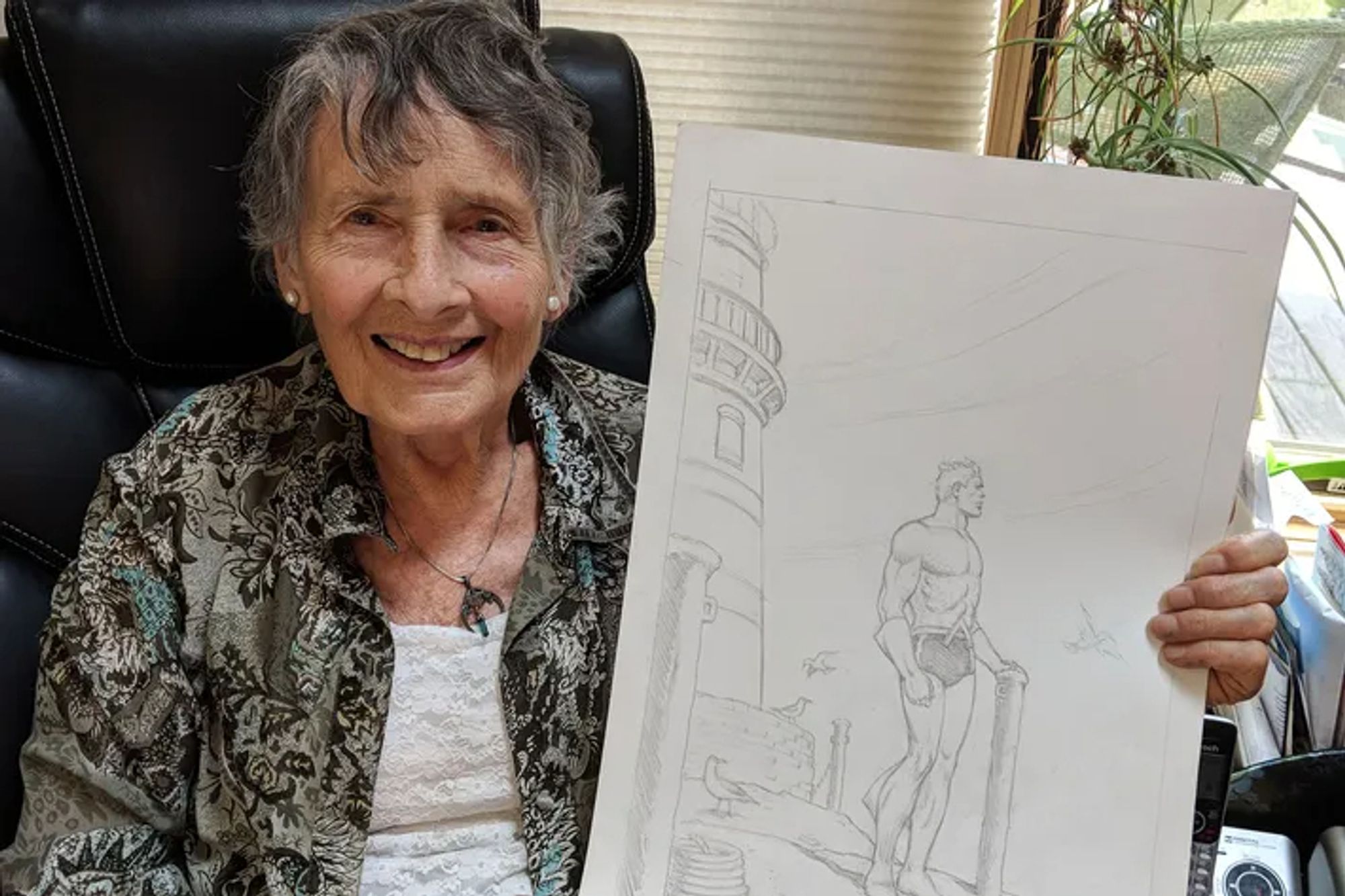 Cartoonist Ramona Fradon holds up an illustration of Aquaman