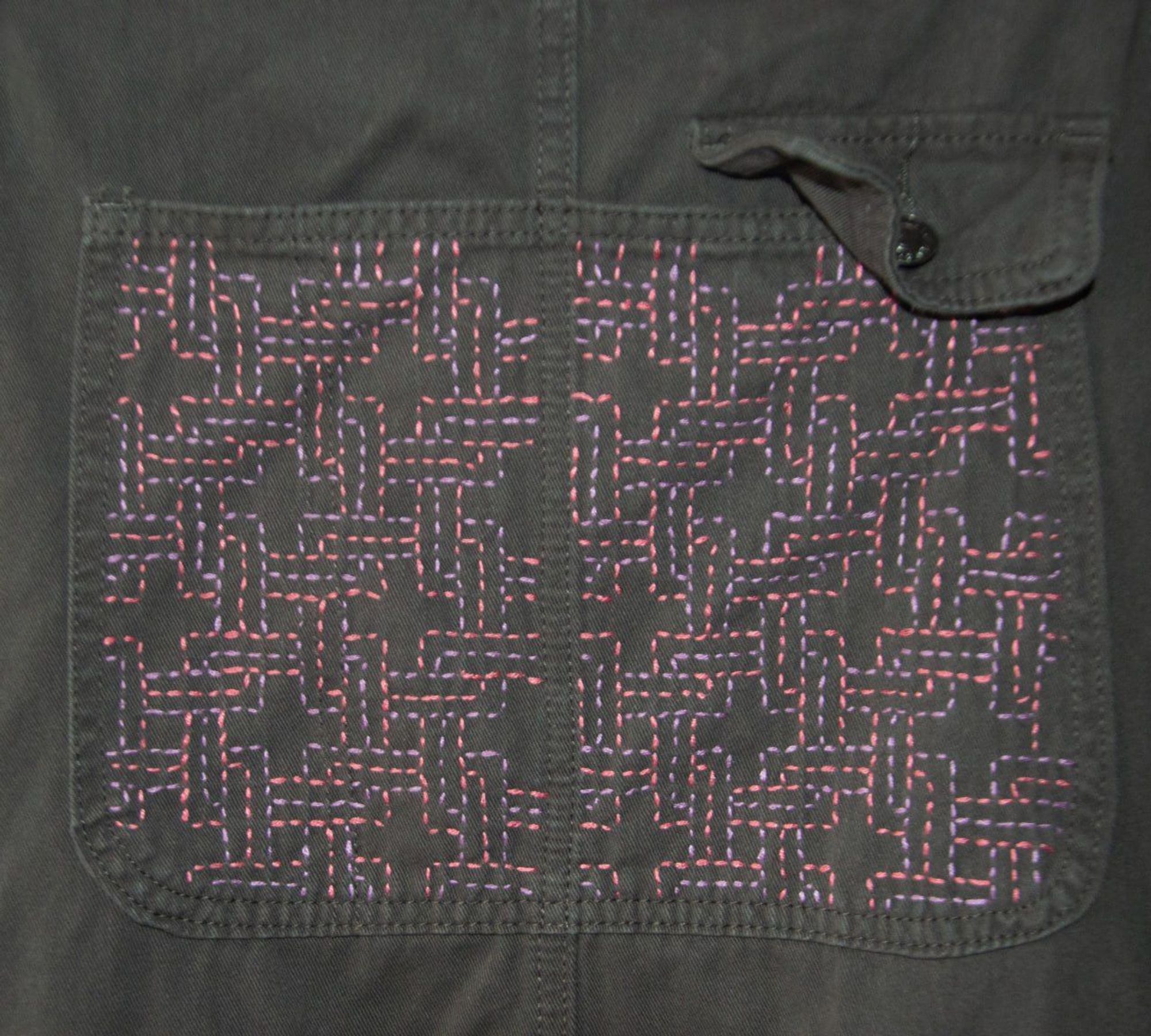 A detail of an embroidery on a overall inspired by the Rokuyata-Koshi pattern of the Japanese Sashiko style