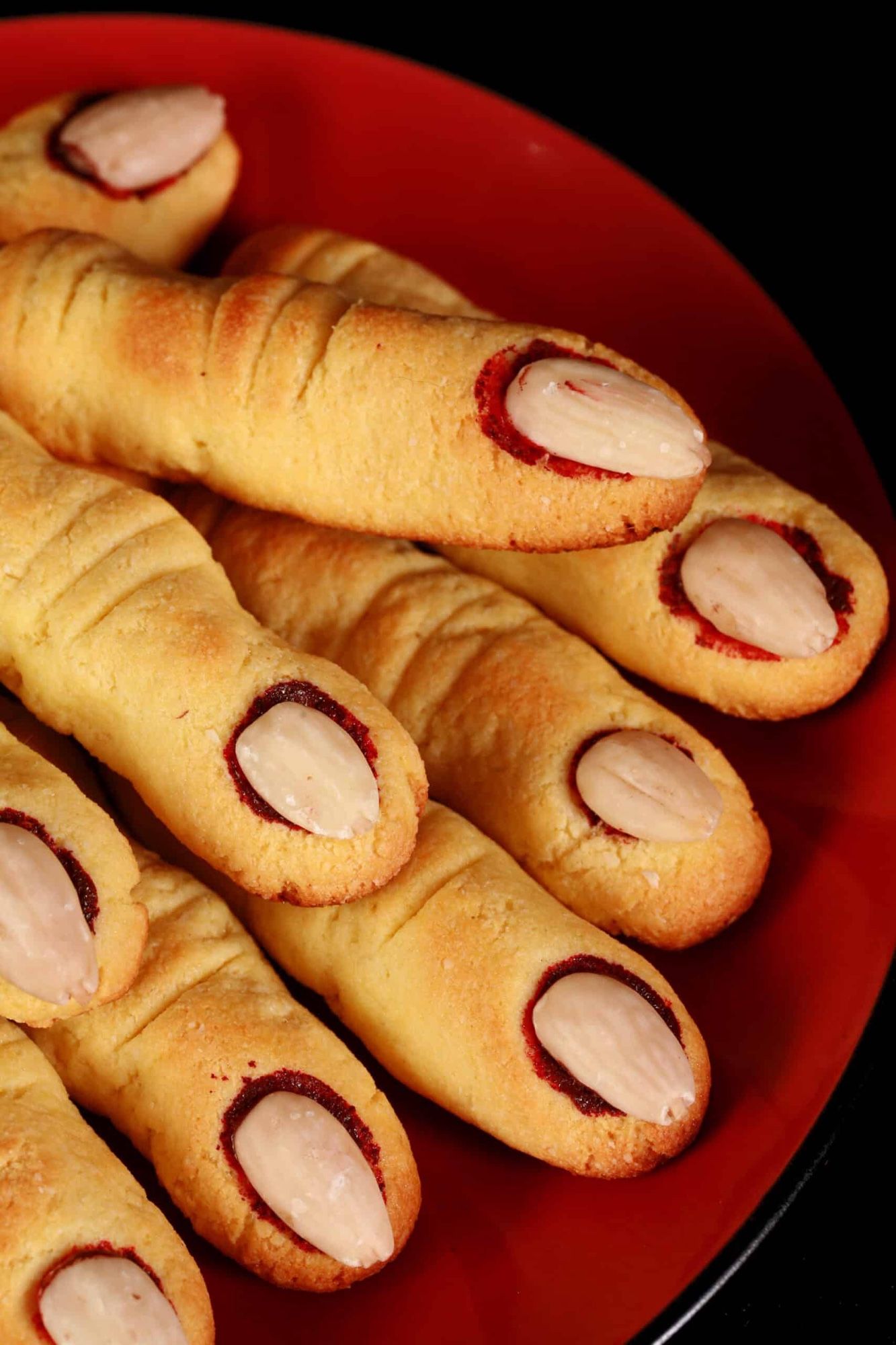 Shortbread cookies shaped like fingers with an almond for a fingernail