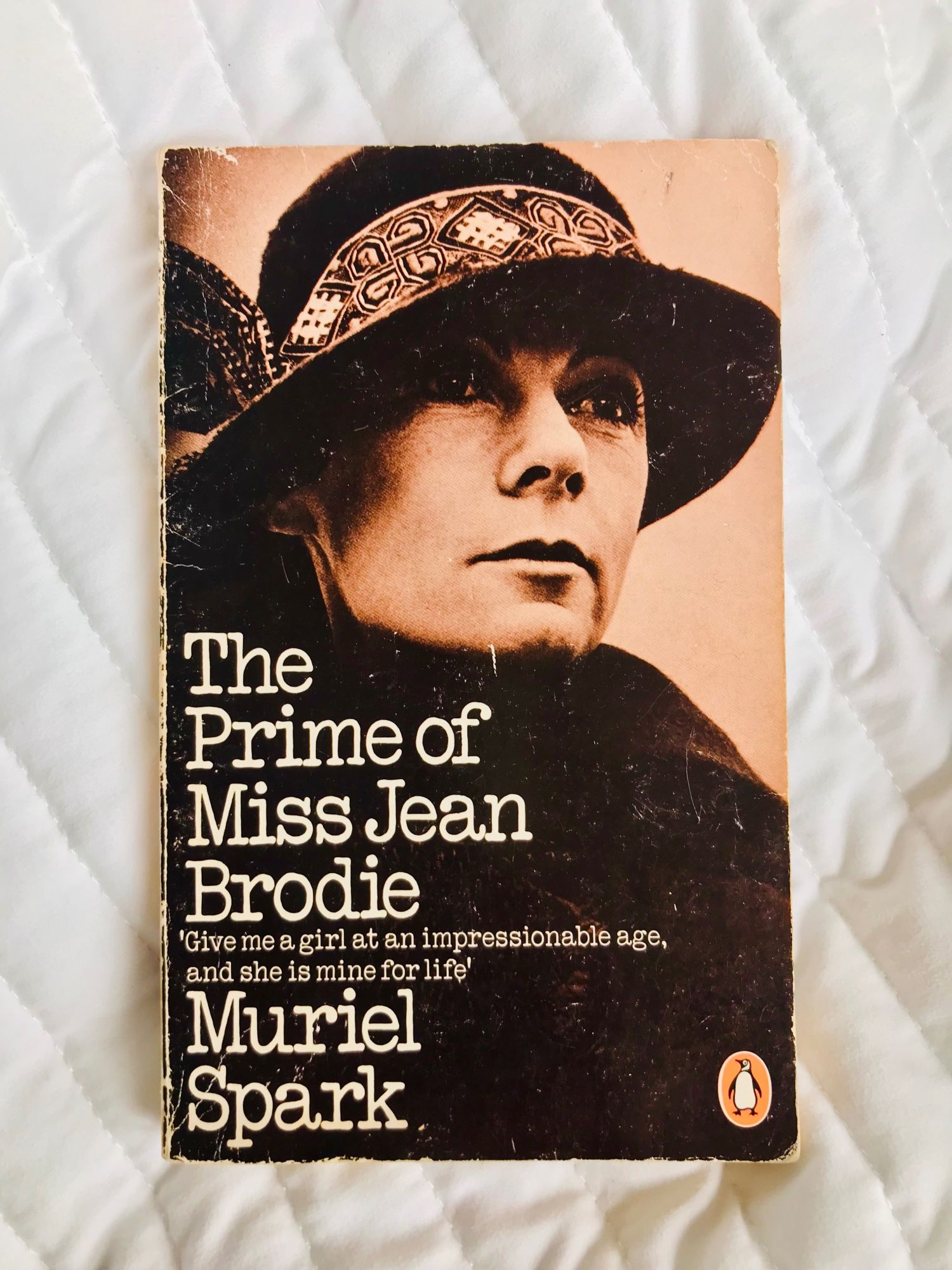 1980 Penguin paperback cover of The Prime Miss Jean Brodie, with a photo of Geraldine McEwan from the 1978 TV version. She is wearing a wool hat with a brim and Celtic designs, and looking beautiful.