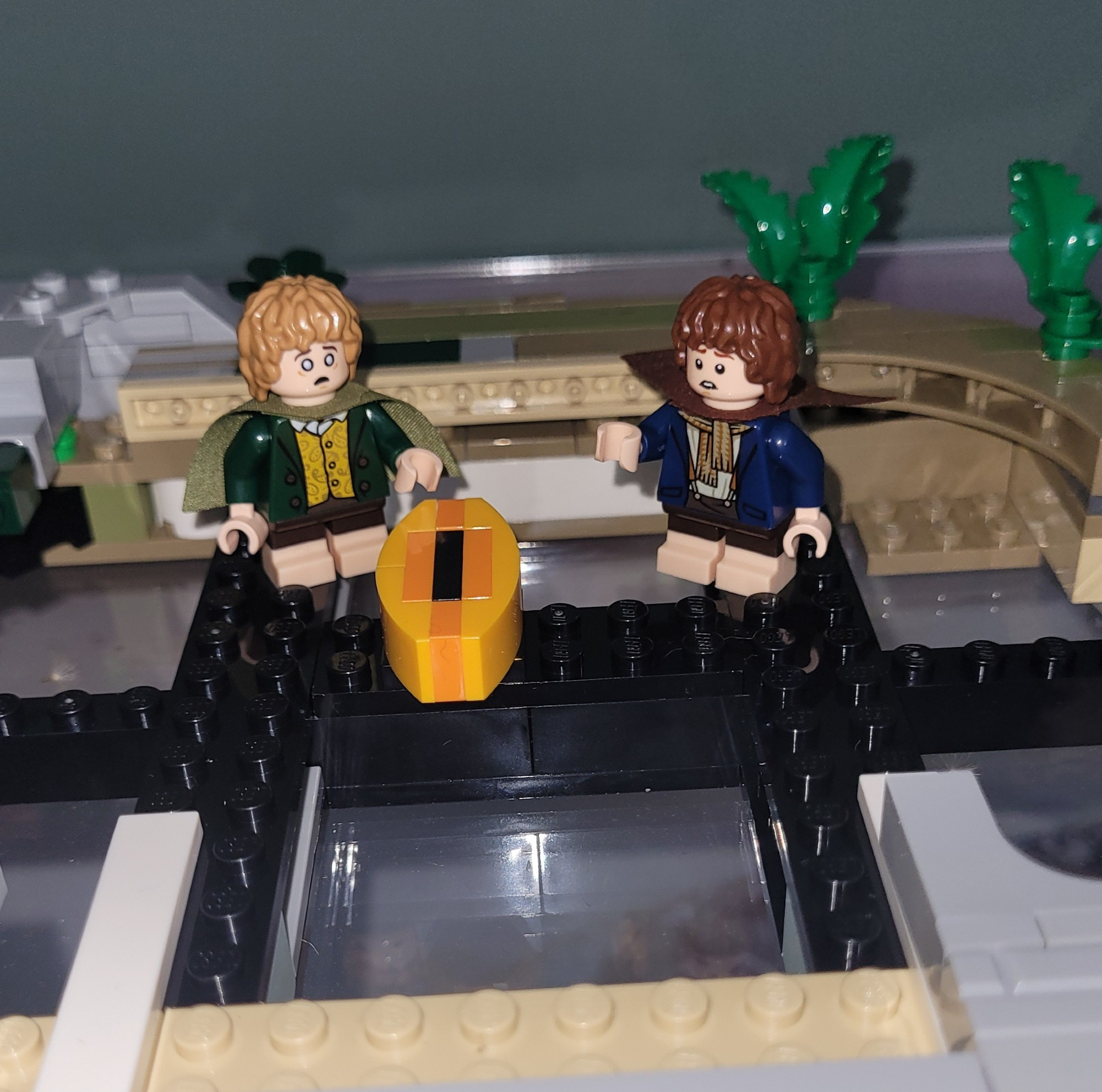 Lego figurines of Lord of the Rings characters Merry and Pippin have found a structure that resembles Sauron's Eye deep in the foundations of lego Rivendell