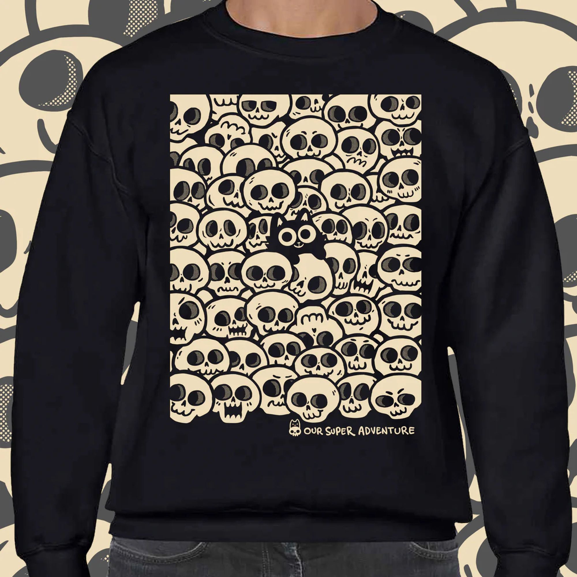 A sweater mock up featuring a small happy black cat surrounded by skulls!