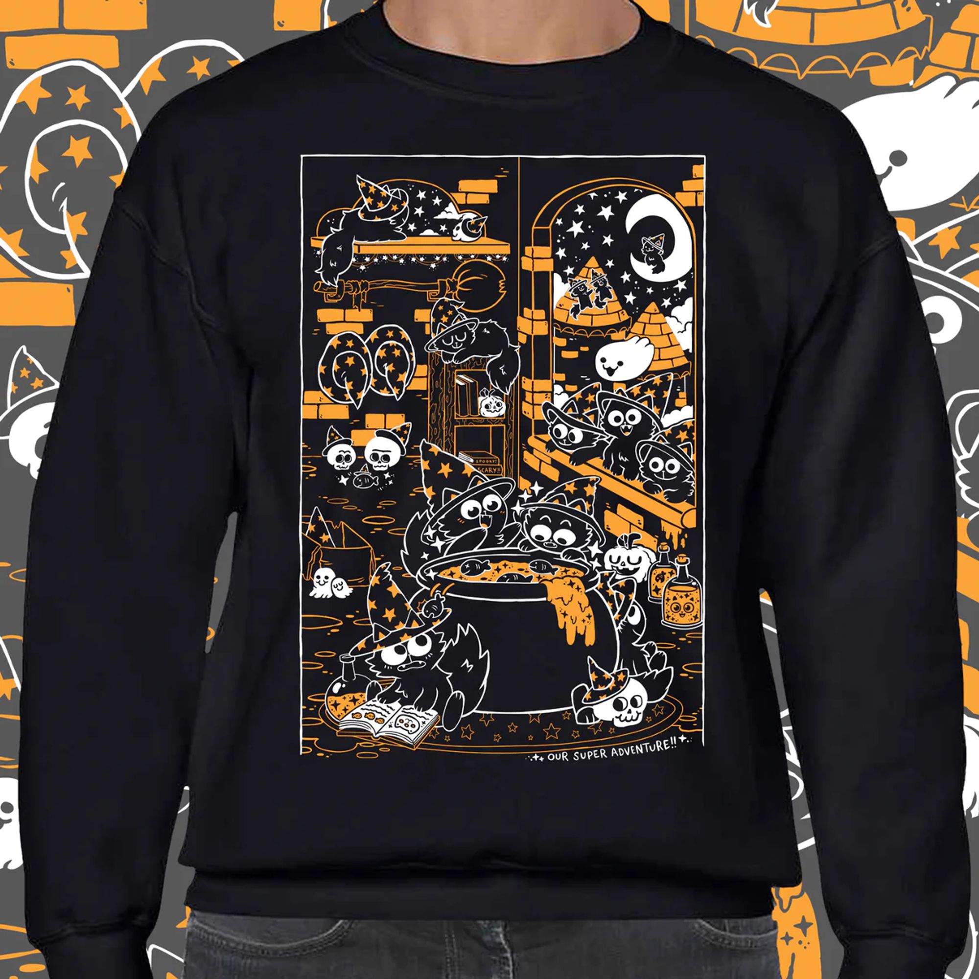 A sweater mock up - the sweater is black and the print is orange and white featuring lots of wizard hat wearing cats!