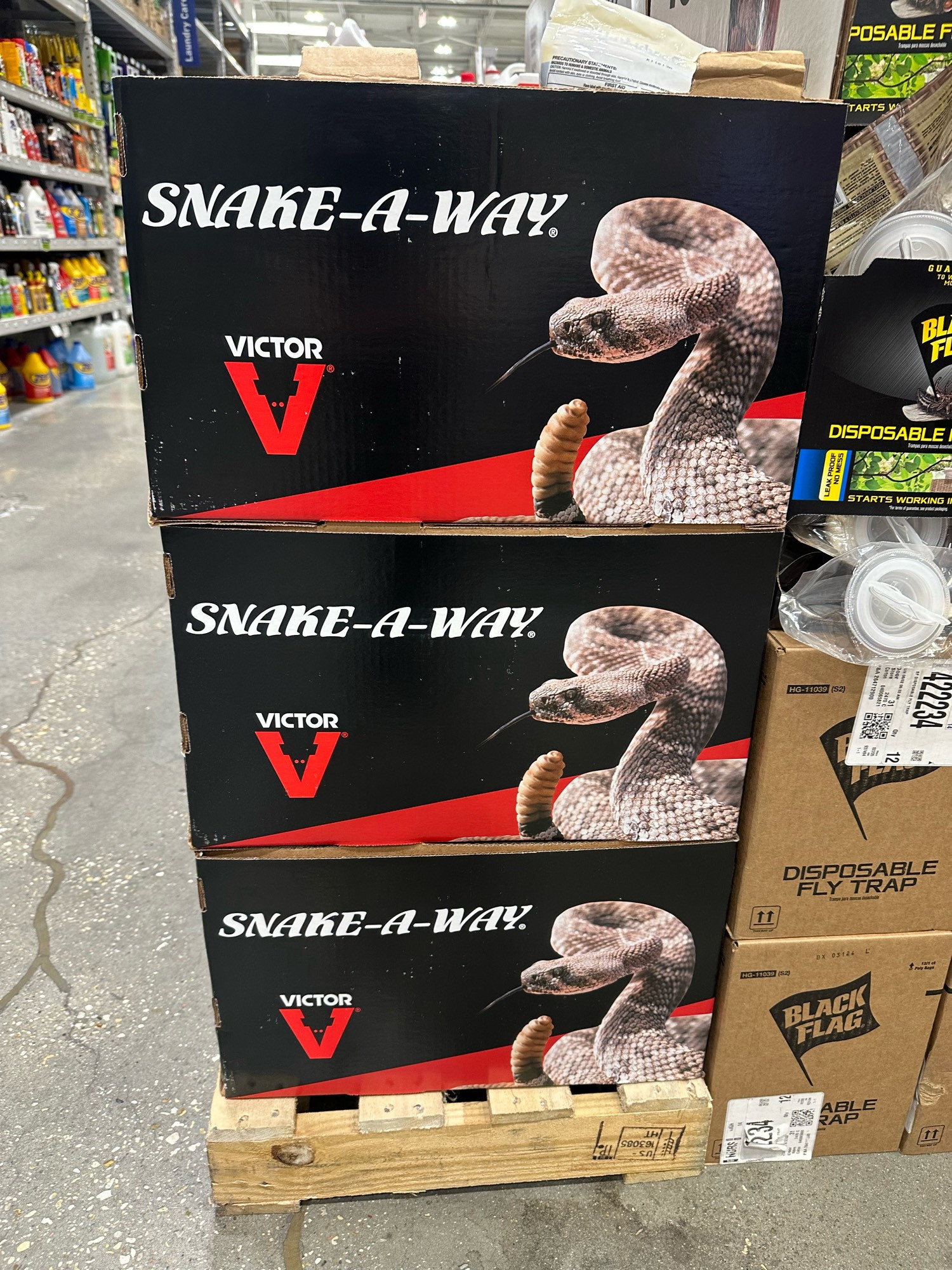 Hardware store display of three stacked boxes that say Snake-A-Way