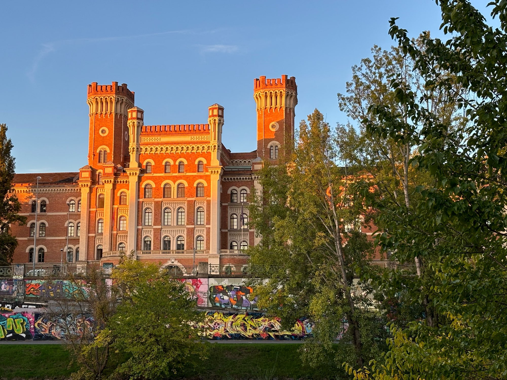 rotes Ziegelgebäude mit Türmchen vor blauem Himmel