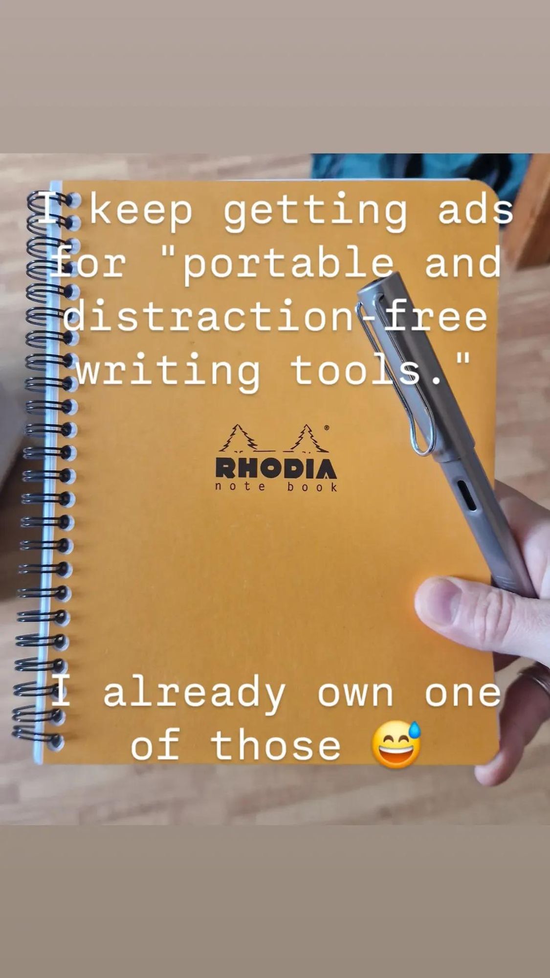 A picture of me holding a notebook and a fountain pen. The text says "I keep getting ads for distraction free writing tools. I already own one of those."