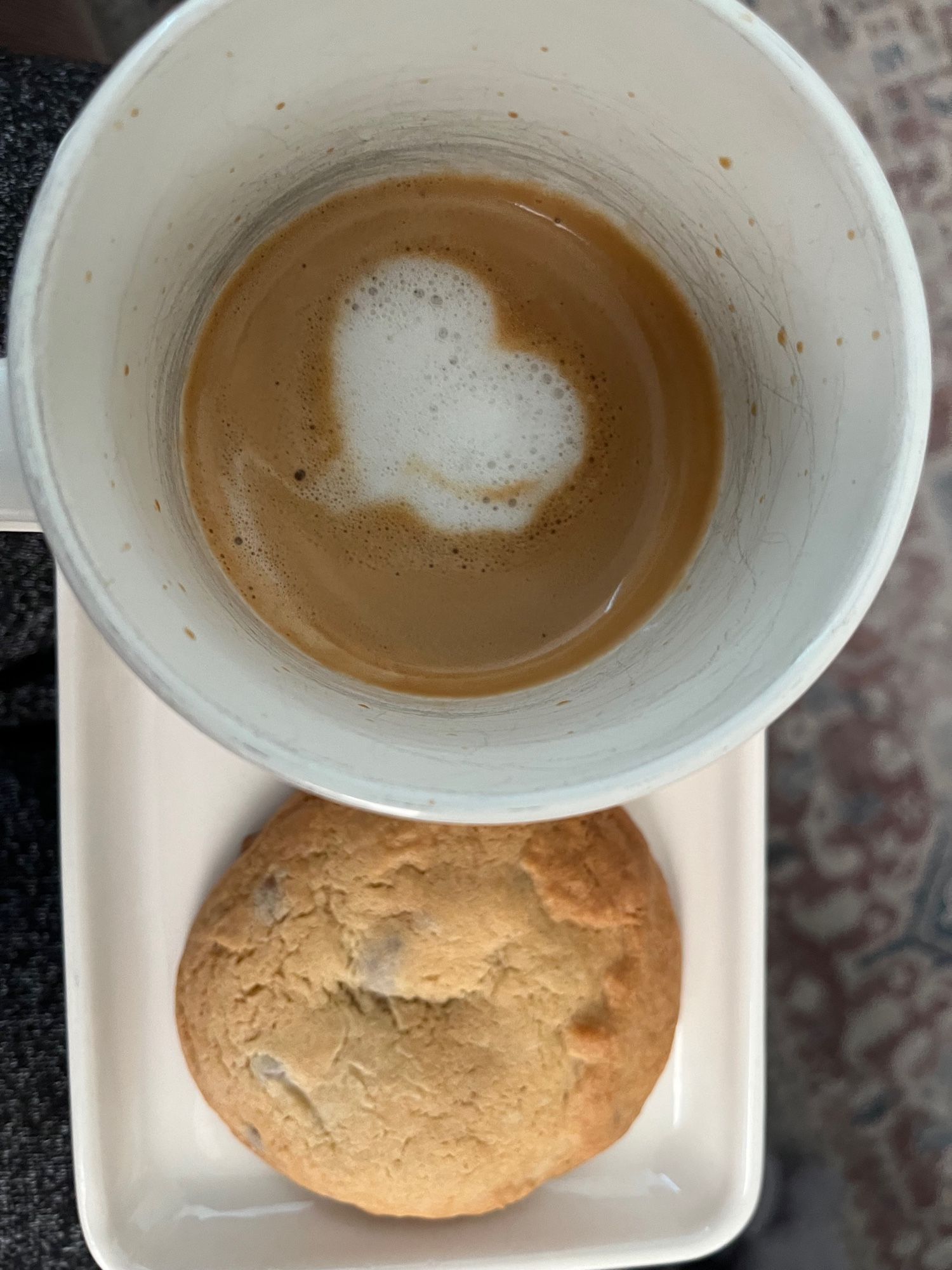 Homemade chocolate chip cookie and a cafe latte with a heart