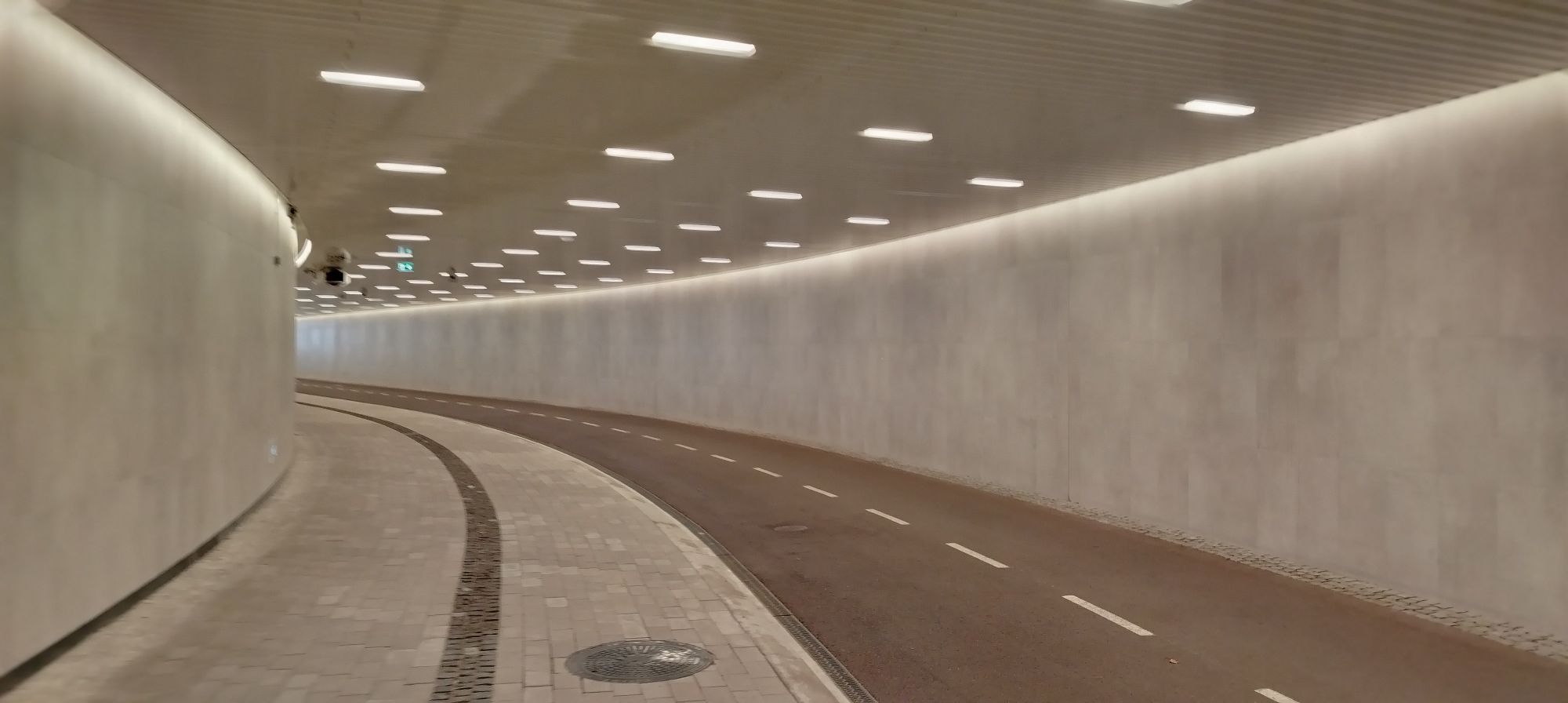 In the tunnel- wide two way asphalt cycle road and raised wide pedestrian walk