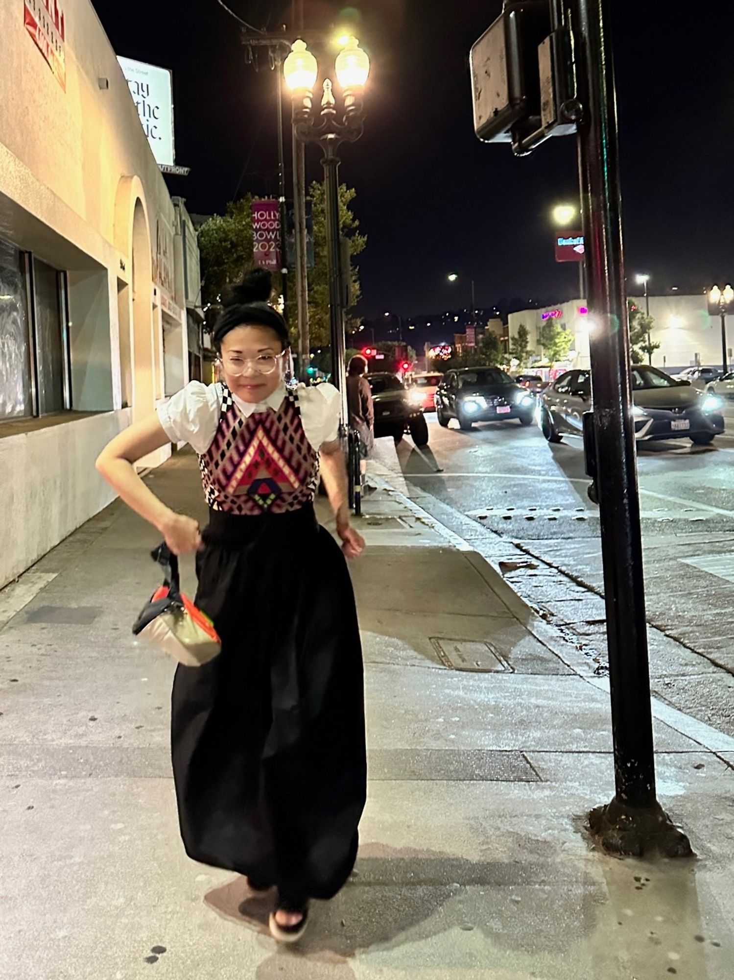 Woman with a poofy black skirt walking down the street