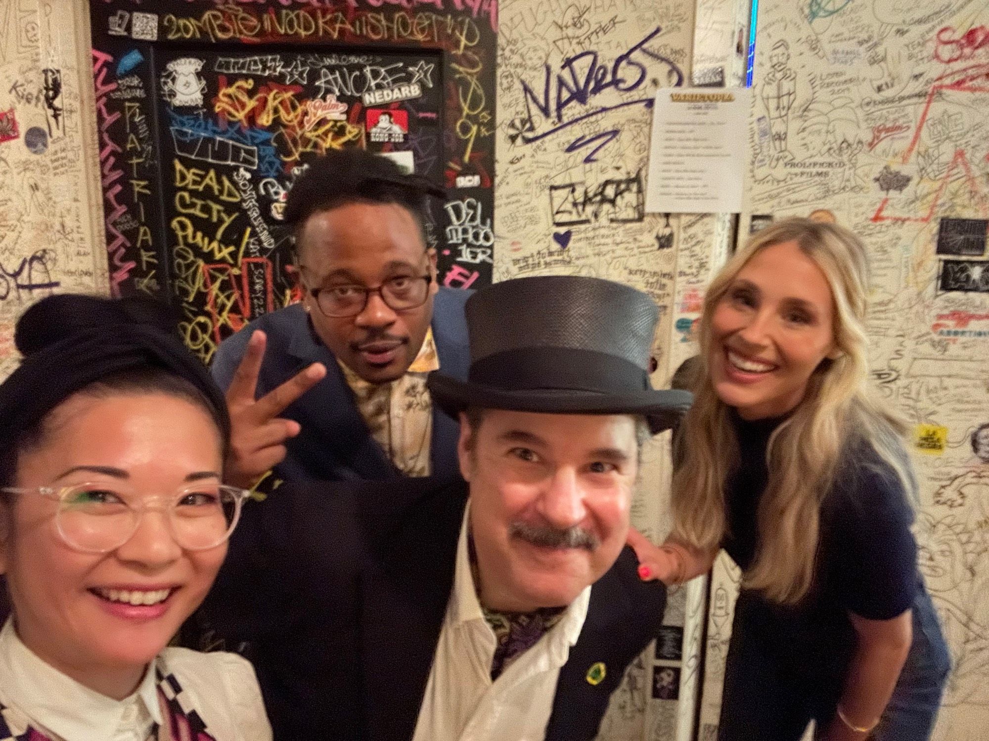 Four performers backstage in a group selfie