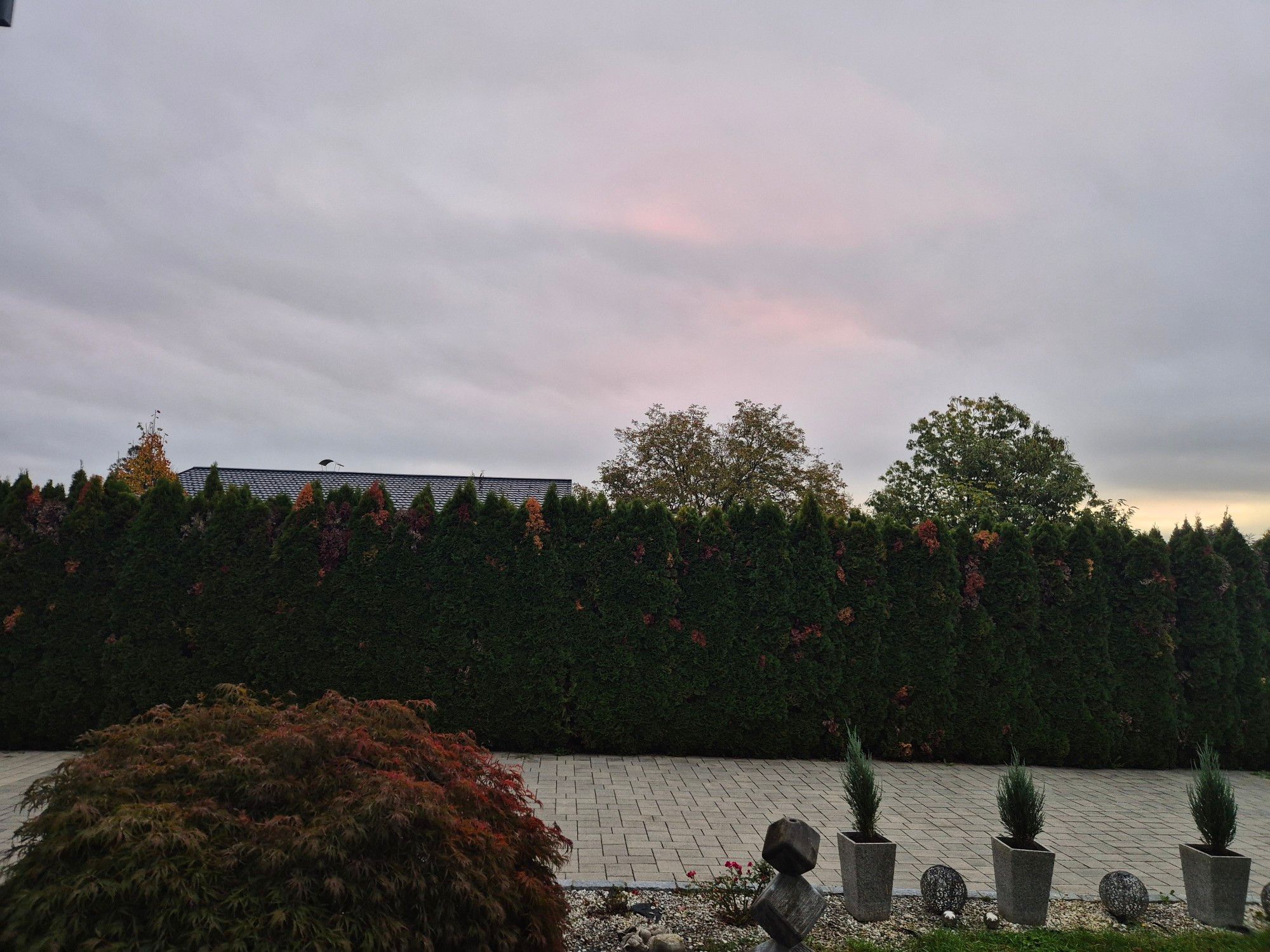 Blick Richtung Osten: Hinter dichten Wolken verbirgt sich der Sonnenaufgang. Die grauen Wolken zeigen einen leichte rosa Färbung. 