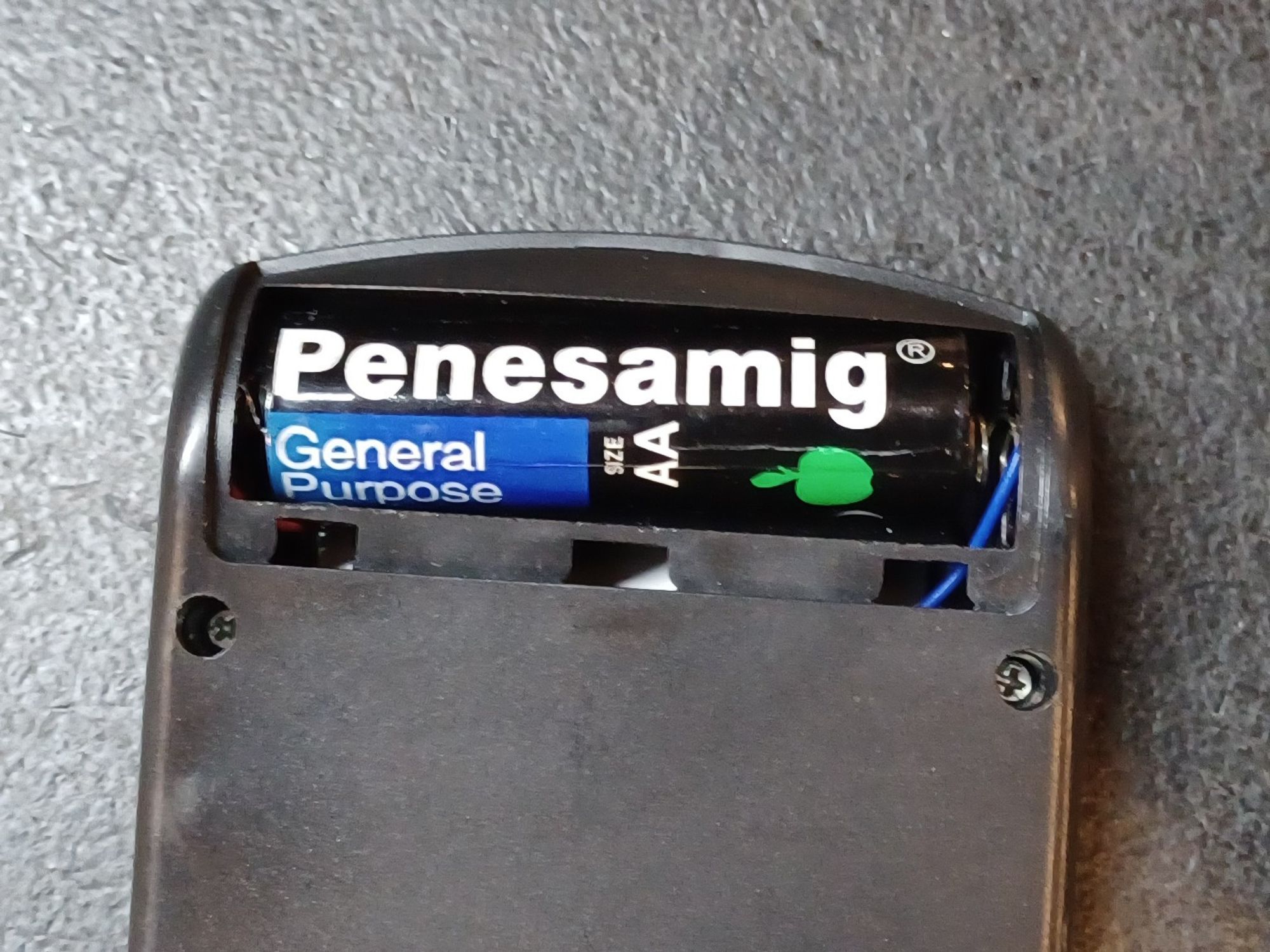 knockoff "Penesamig" AA battery in a cheap calculator