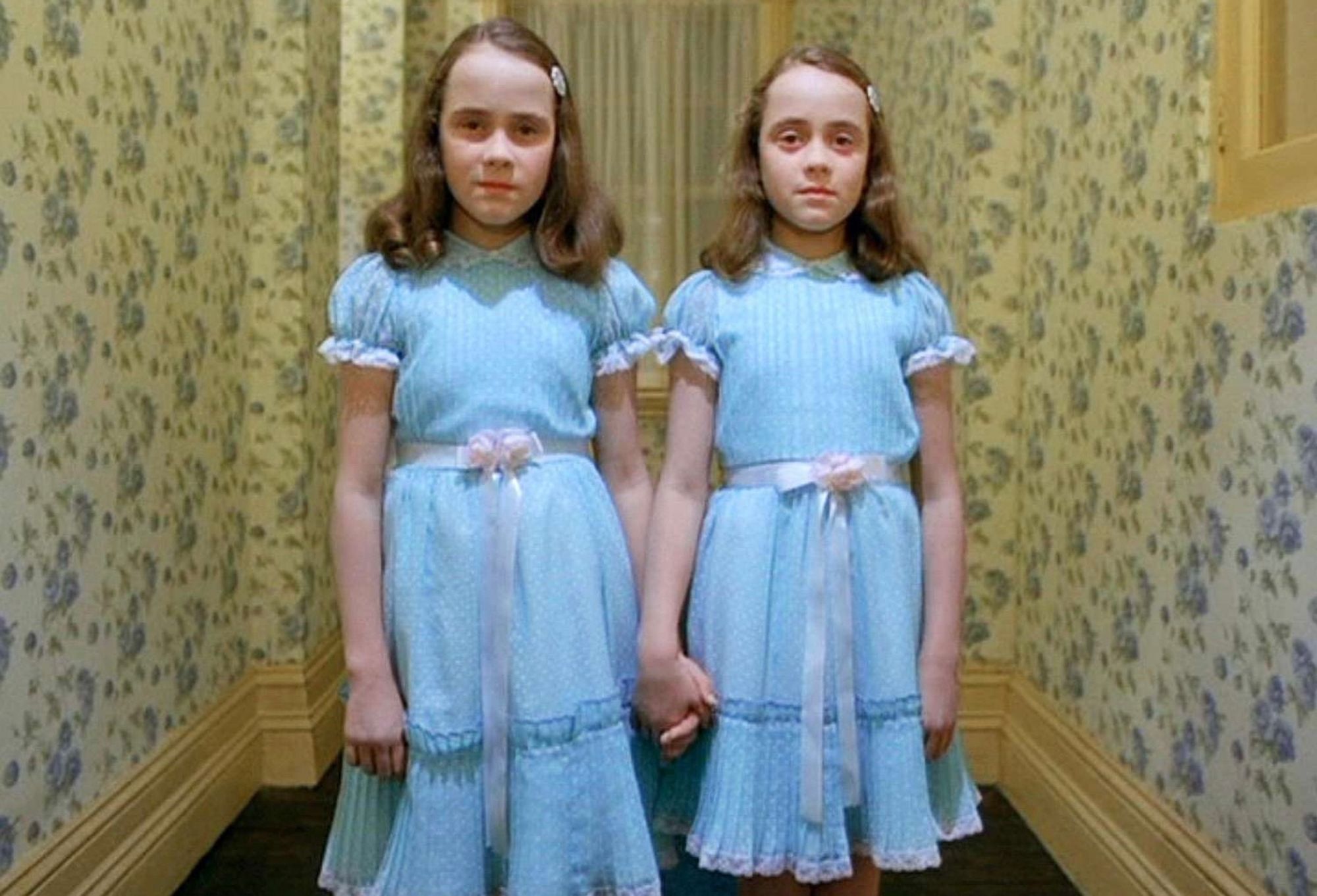 the creepy twins from the shining. they’re two girls with shoulder-length blonde hair in matching blue babydoll dresses with pink ribbons tied around their waists. they’re fittingly pale as ghosts as they stand in the hallway of the overlook hotel. it has 1.5 stars on yelp for having scenic views but the random bursts of blood in the elevators sure stain a vacation.