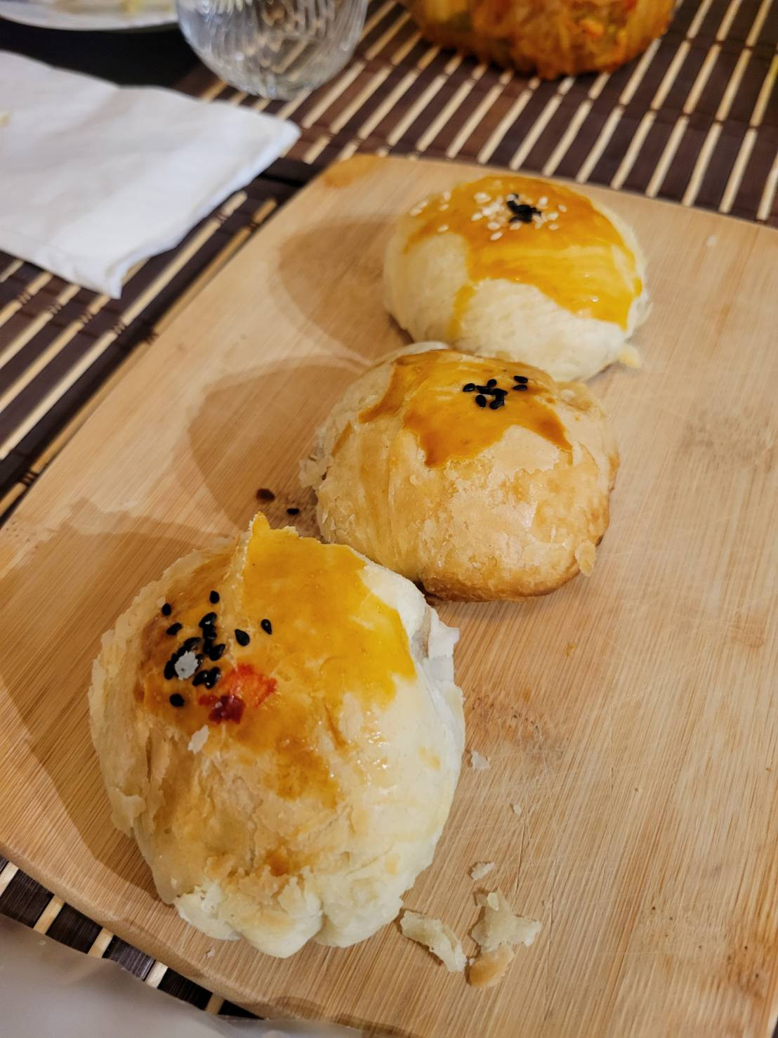 3 rustic style mooncakes on a cutting board