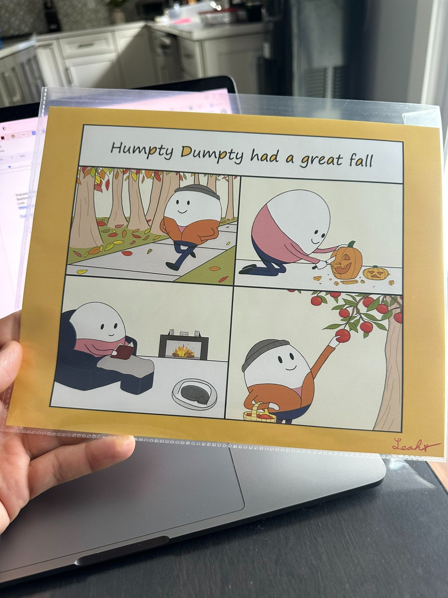 A print of a wholesome meme by artist Rachel Greenberg featuring children’s legend Humpty Dumpty having “a great fall”—talking a walk in the park, carving a pumpkin, reading a book by the fire, and apple-picking.