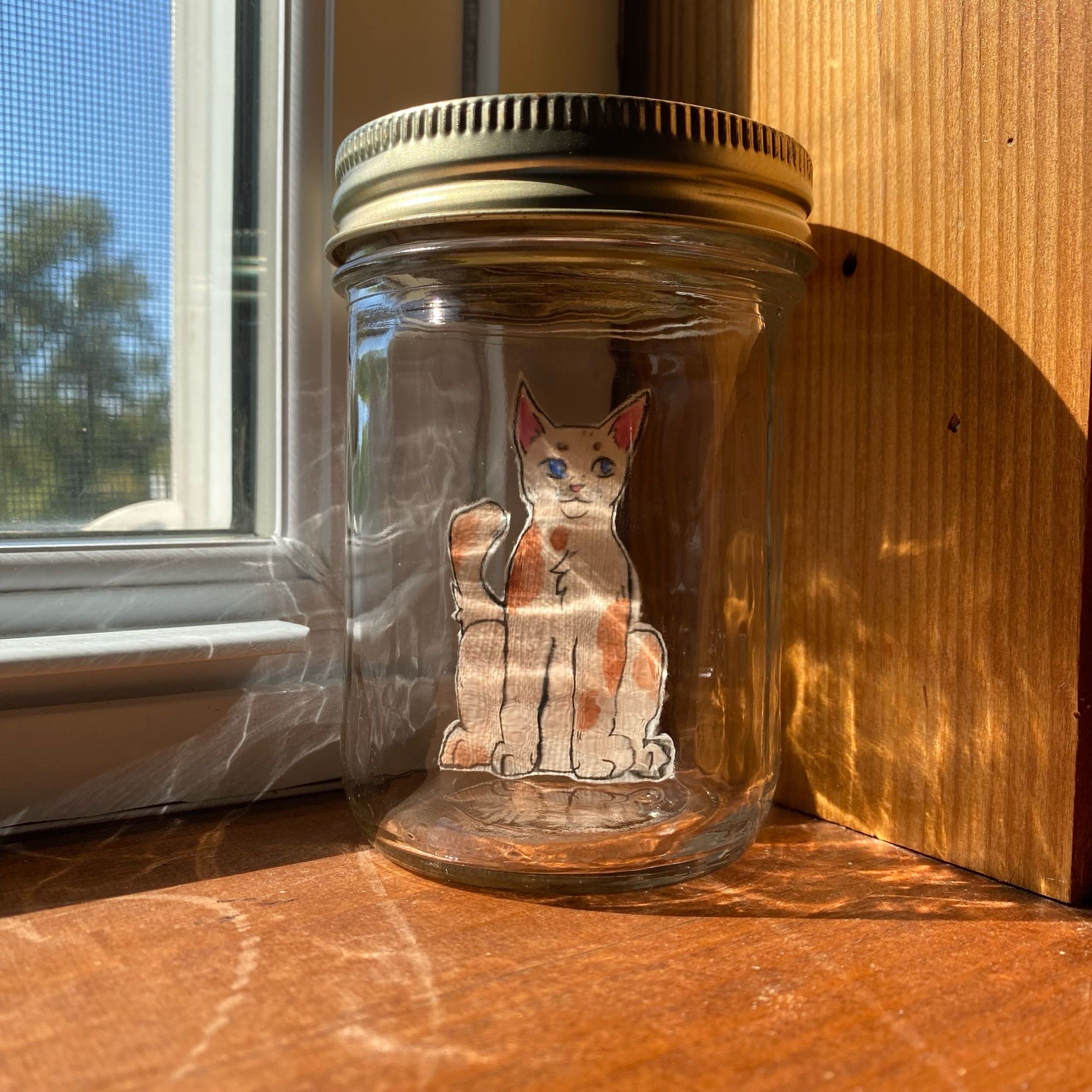 Photo of a cat drawing in a jar