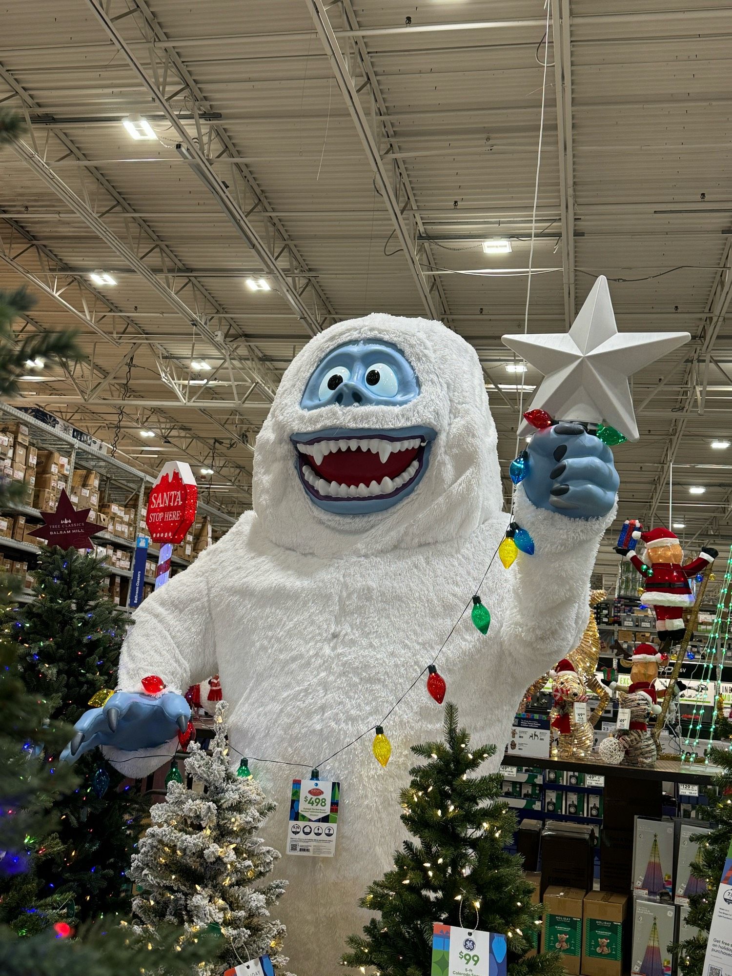 A large (10 foot?) yard decoration of Bumble, the abominable snowman from the televised Rudolph the Red Nosed Reindeer classic, holding a star for atop a Christmas tree