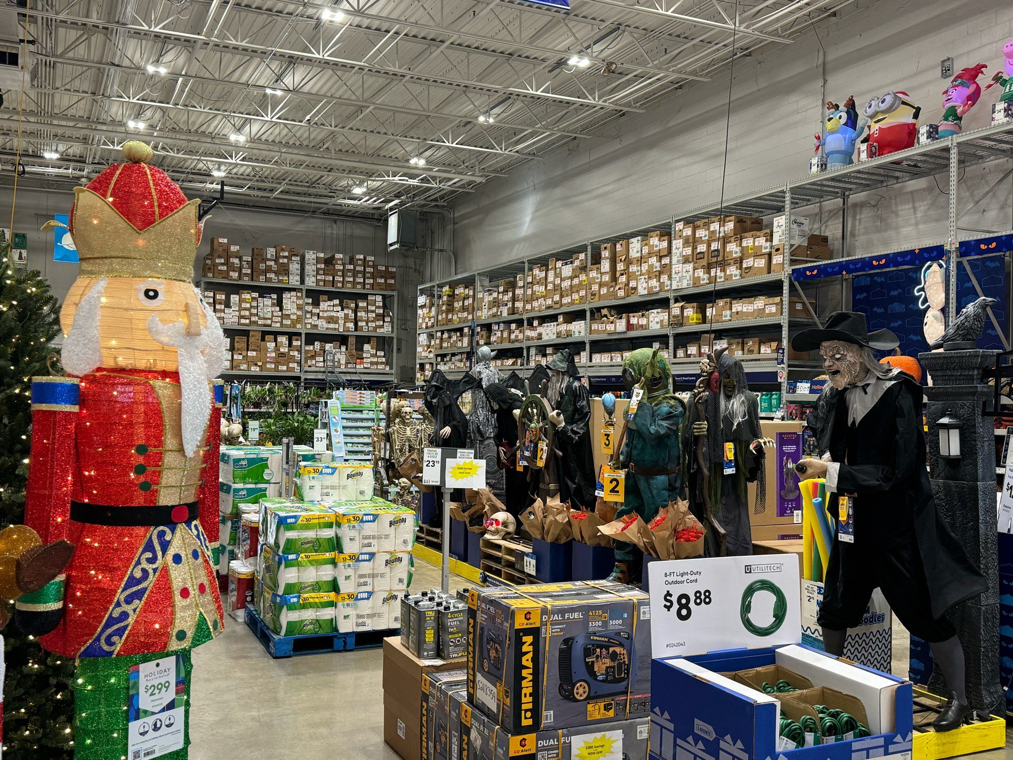 Picture of Halloween yard decorations facing a Christmas Nutcracker yard decoration in Lowe's. The spooky ones seem to be striding menacingly toward the Nutcracker.