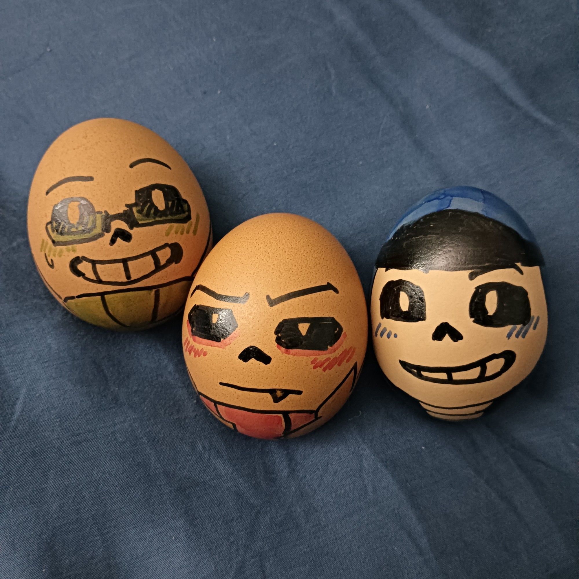 Three eggs drawn with faces. From left to right: Sci, Edge and Dance.