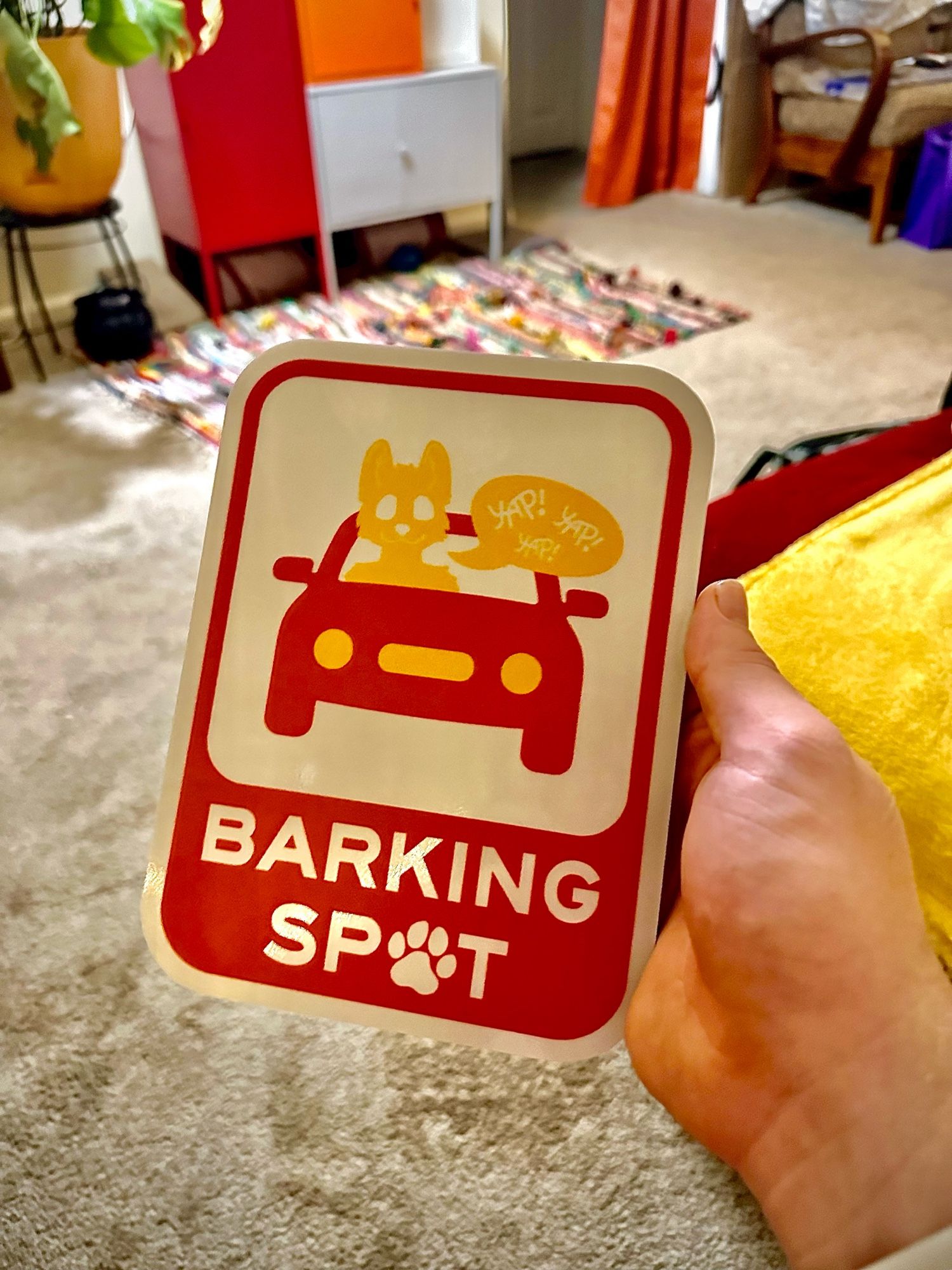 Photo of me holding the Barking Spot sign irl because it’s real now i actually got it printed