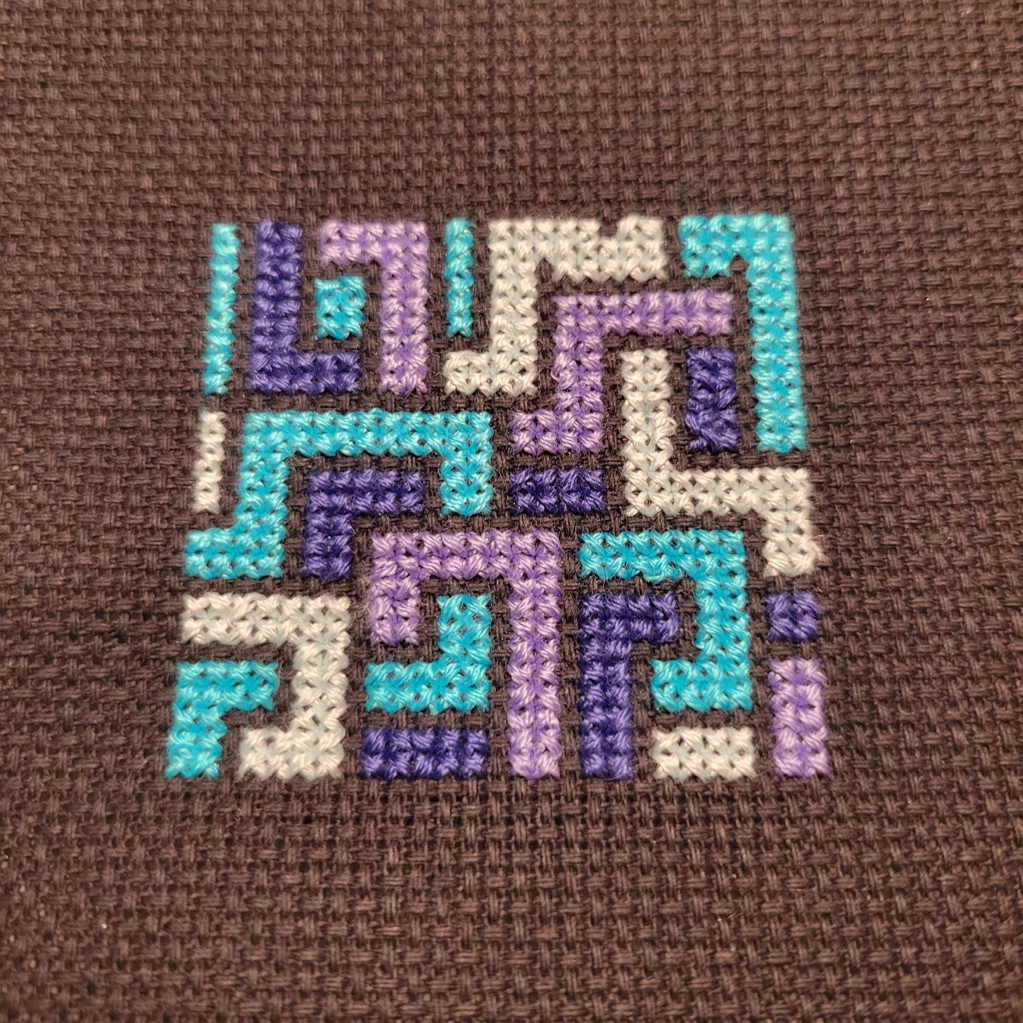 a cross stitch pattern of tangled square lines in blues and purple