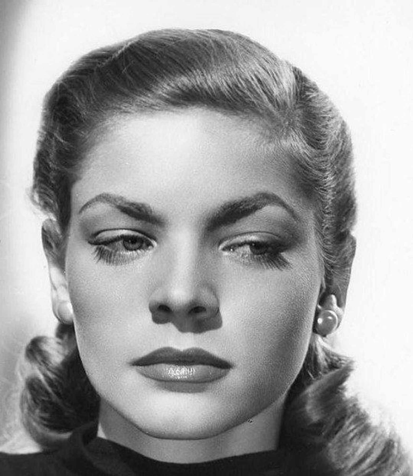 Lauren Bacall in a black-and-white publicity photo, ca. 1945, looking VERY Lauren Bacall.