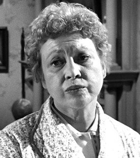 Actress Lorene Tuttle whispers the immortal line "In bed," in a screen grab from Psycho (1960).  