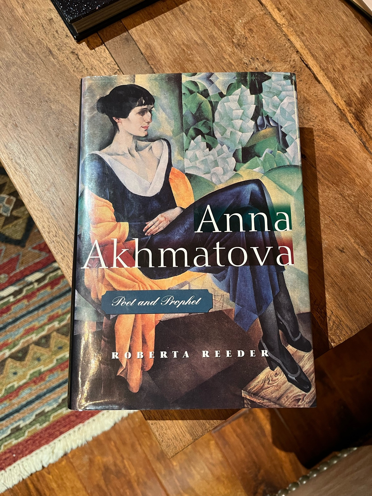 The cover of Anna Akhmatova: Poet and Prophet, by Roberta Reeder, which contains a cubist-y portrait of Anna.