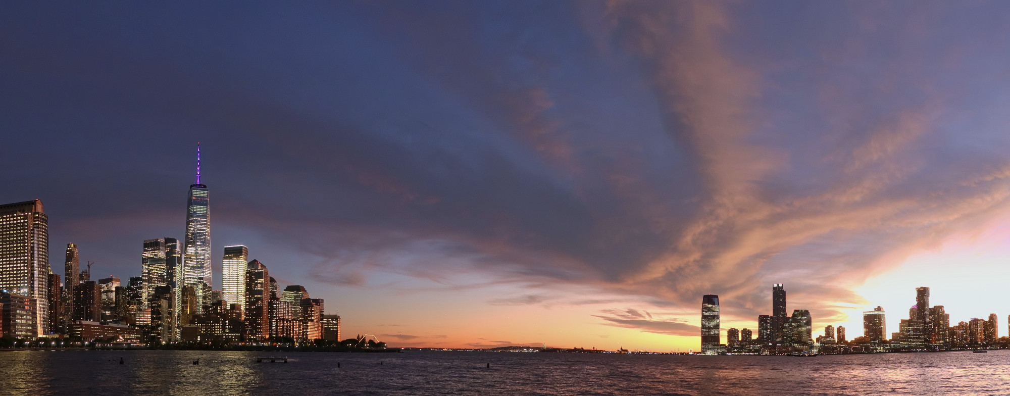 Sunset over lower Manhattan and Jersey City. Seen from Pier 34, looking down the Hudson River.