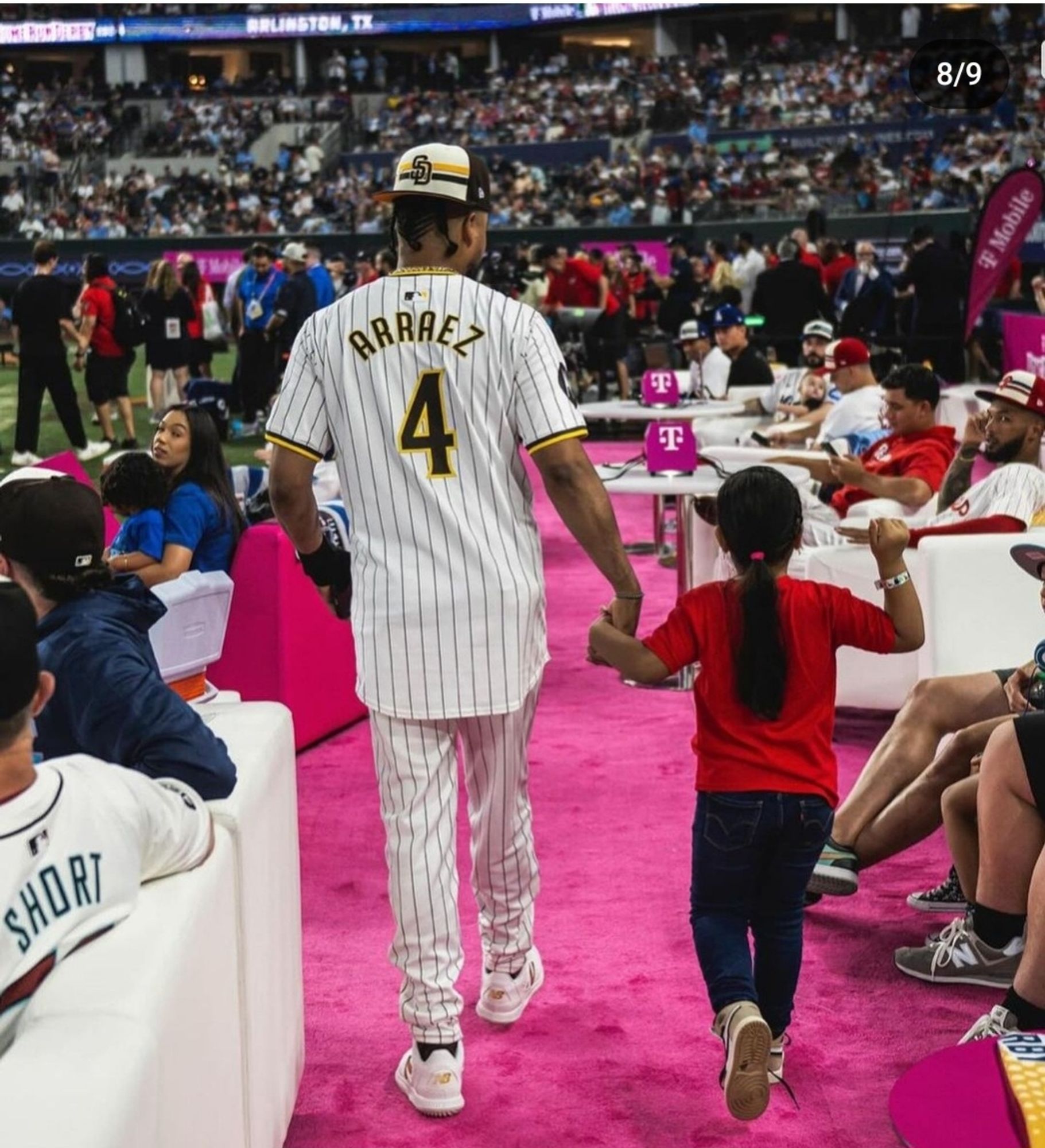 A picture of Arráez walking with his daughter at the all star game. They are holding hands. You can see their backs as they walk through a crowd. Look, I am not big on the entire "girl dad" thing, but Luis seems like a great dad.