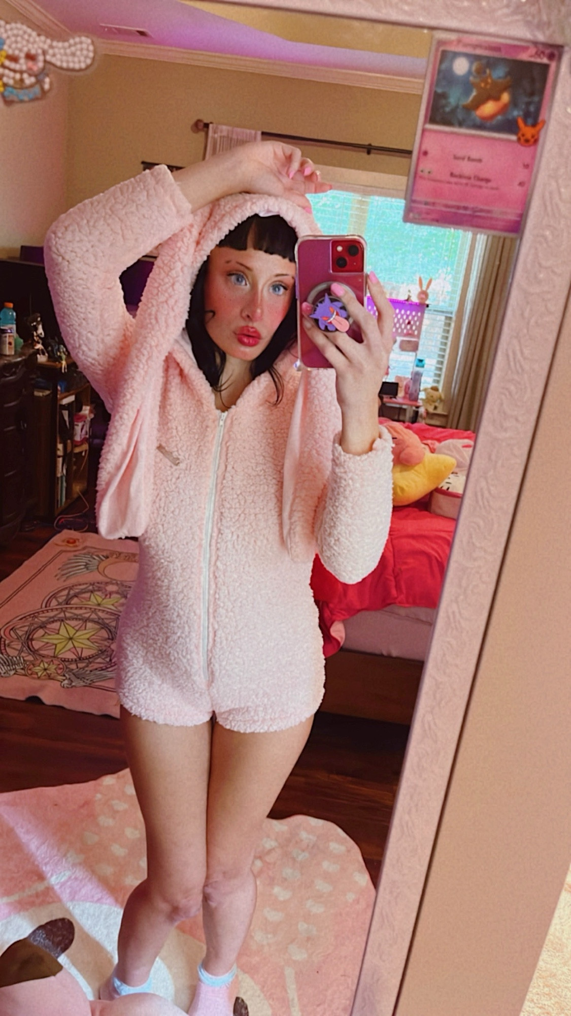 mirror selfie of me with blush heavy makeup staring a pink bunny romper