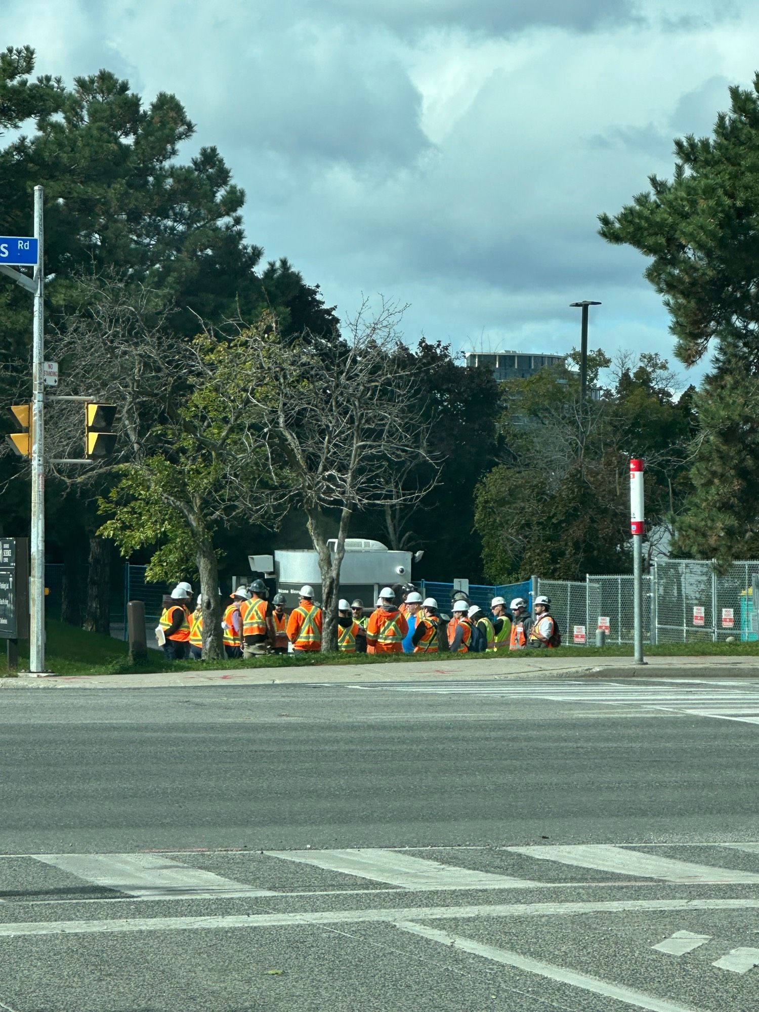 A bunch of people in safety gear and hard hats in front of the Science centre