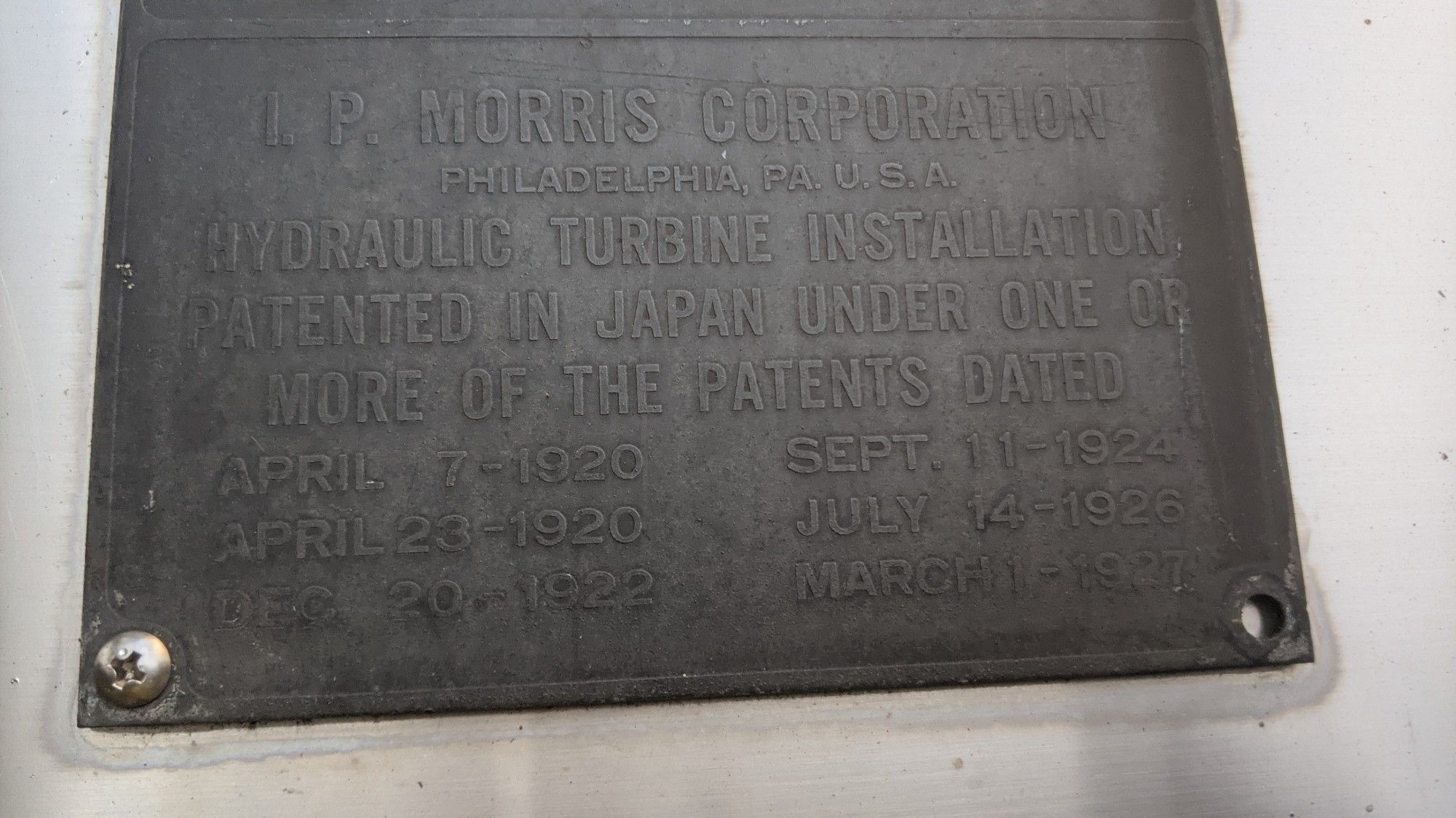 A plaque reading "IP Morris Corporation / Philadelphia PA U.S.A / hydraulic turbine installation patented in Japan under one or more of the patents dated" with six dates from 1920 to 1927.