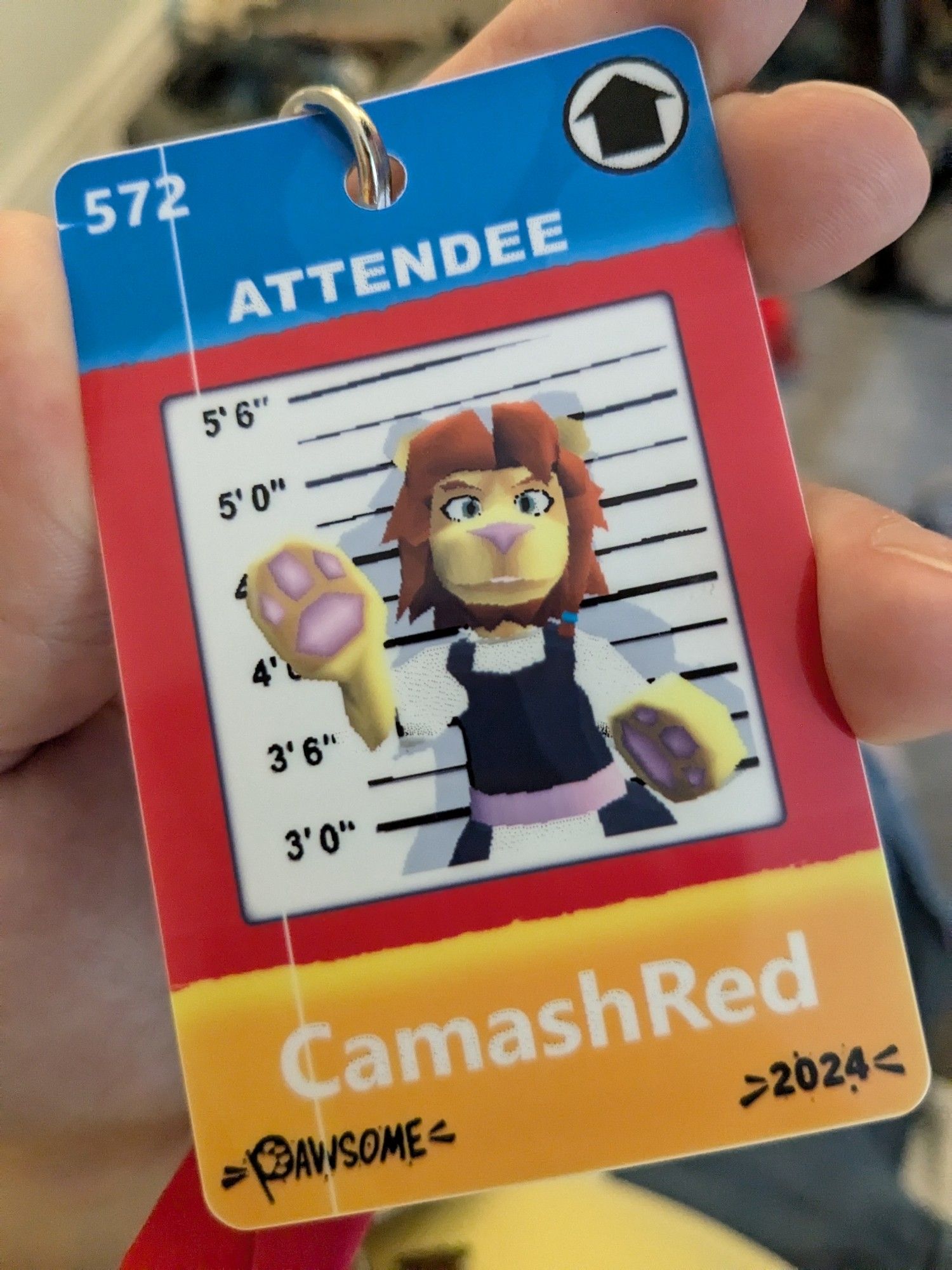 A closeup of a furry conbadge for Pawsome 2024. The picture is of a low poly lion waving wearing a maid dress. The background is a police height chart.