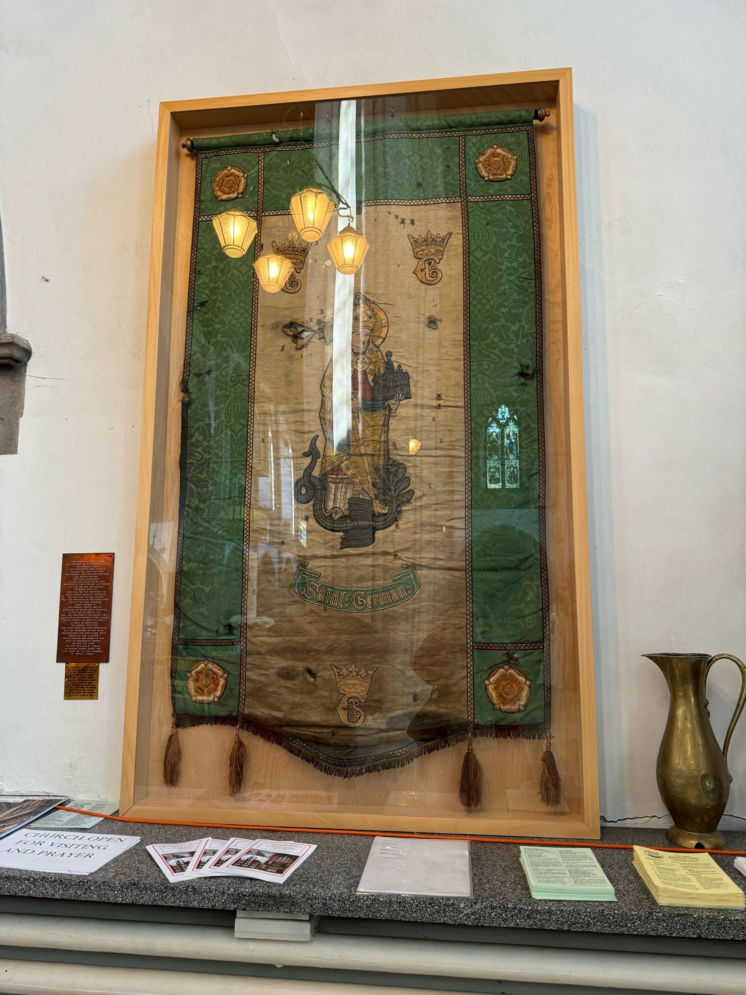 Banner showing St German in pale background with green strips on either side.