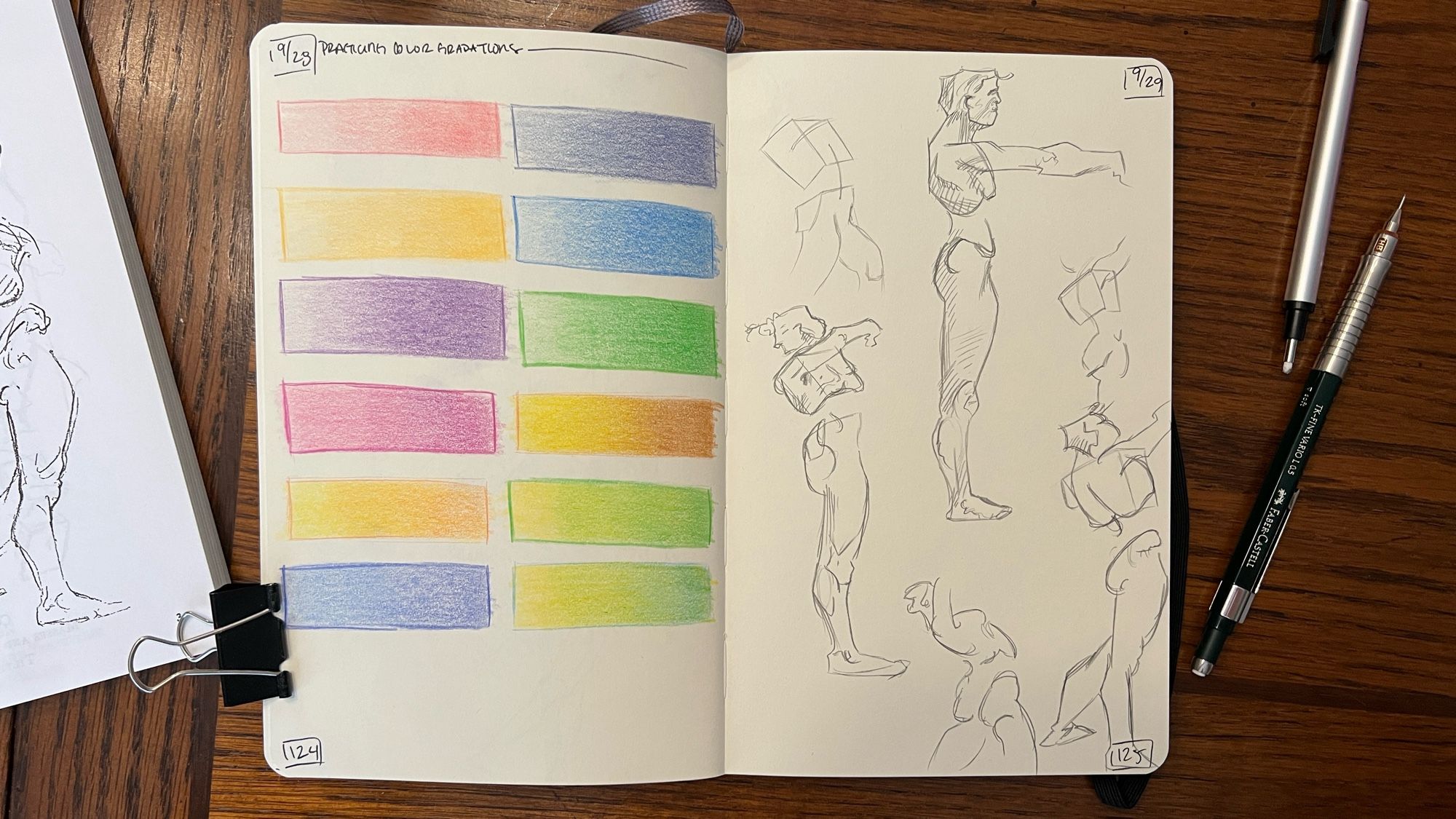 An open sketchbook on a table. The pages are filled with pencil sketches of human form gestures.