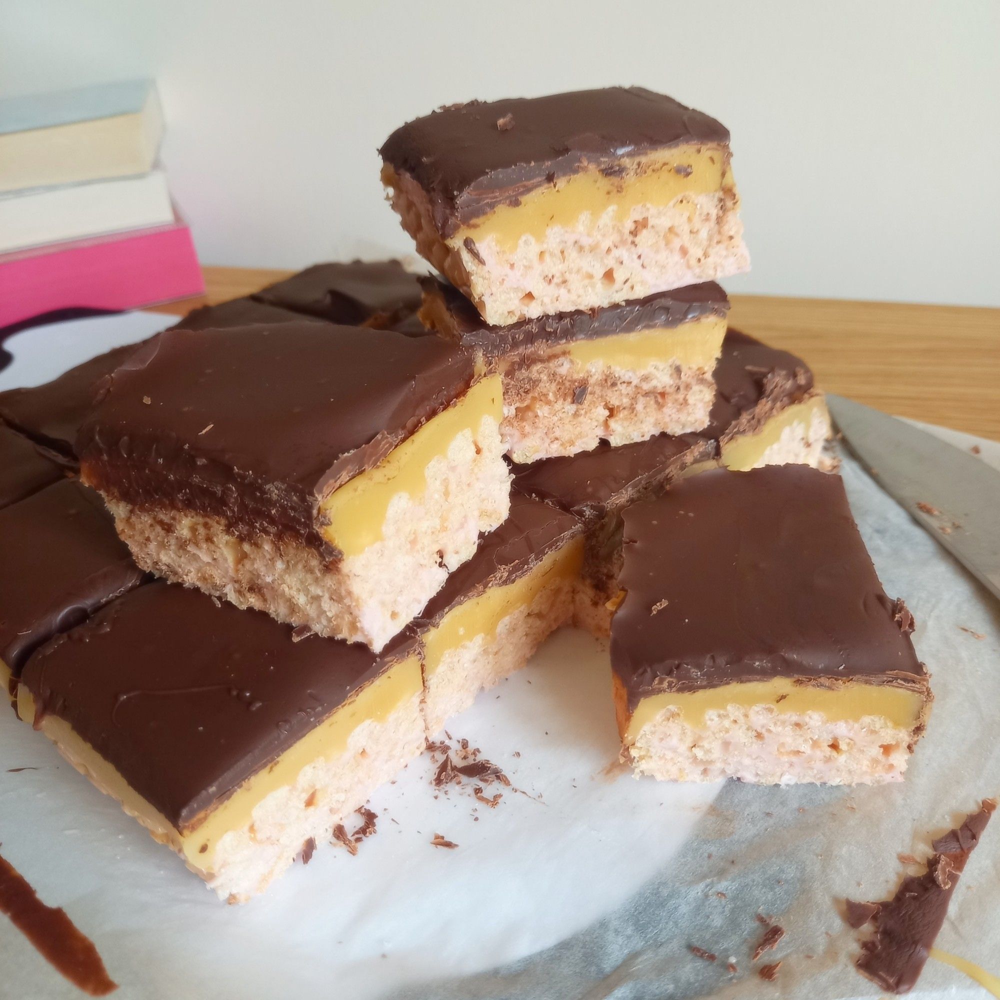 Rice krispie squares with layers of caramel and chocolate