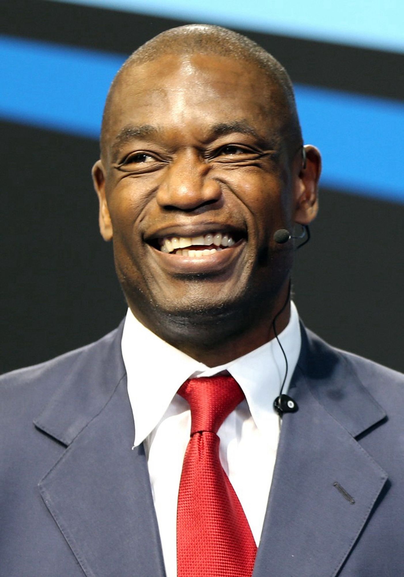 Basketball legend Dikembe Mutombo smiling in a photo