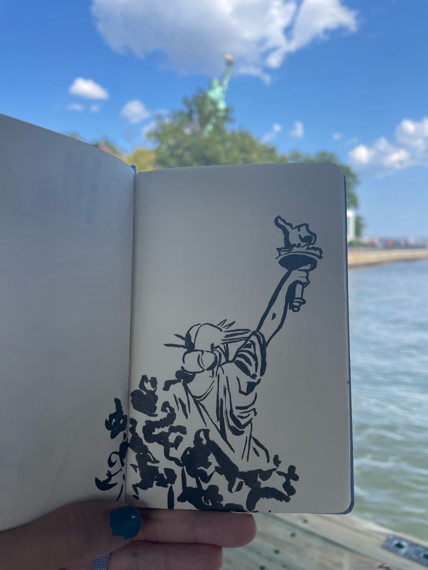 Black ink sketch of The Statue of Liberty as seen from the docks. She is facing away from the viewer and her lower half is hidden by trees.