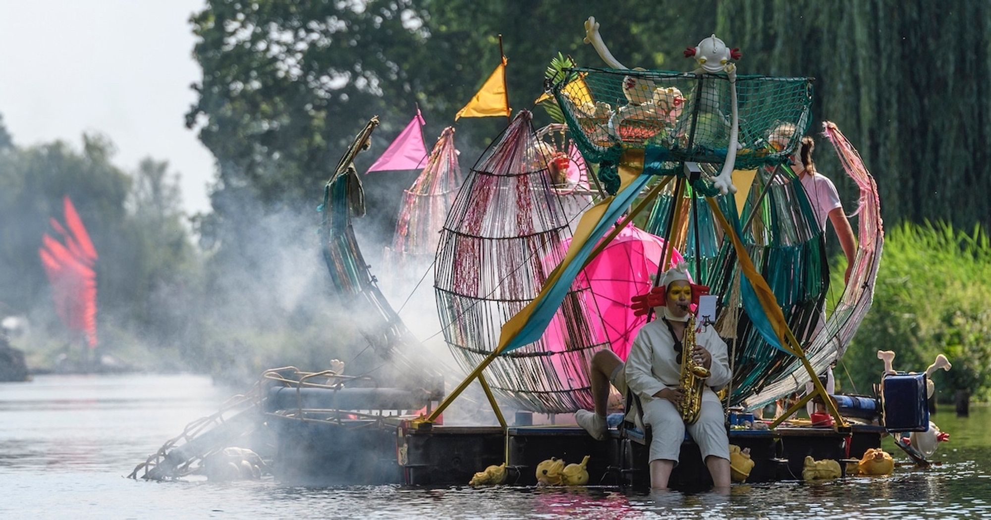 A floating contraption with a man dressed as a 16th century Dutch peasant playing the saxophone.