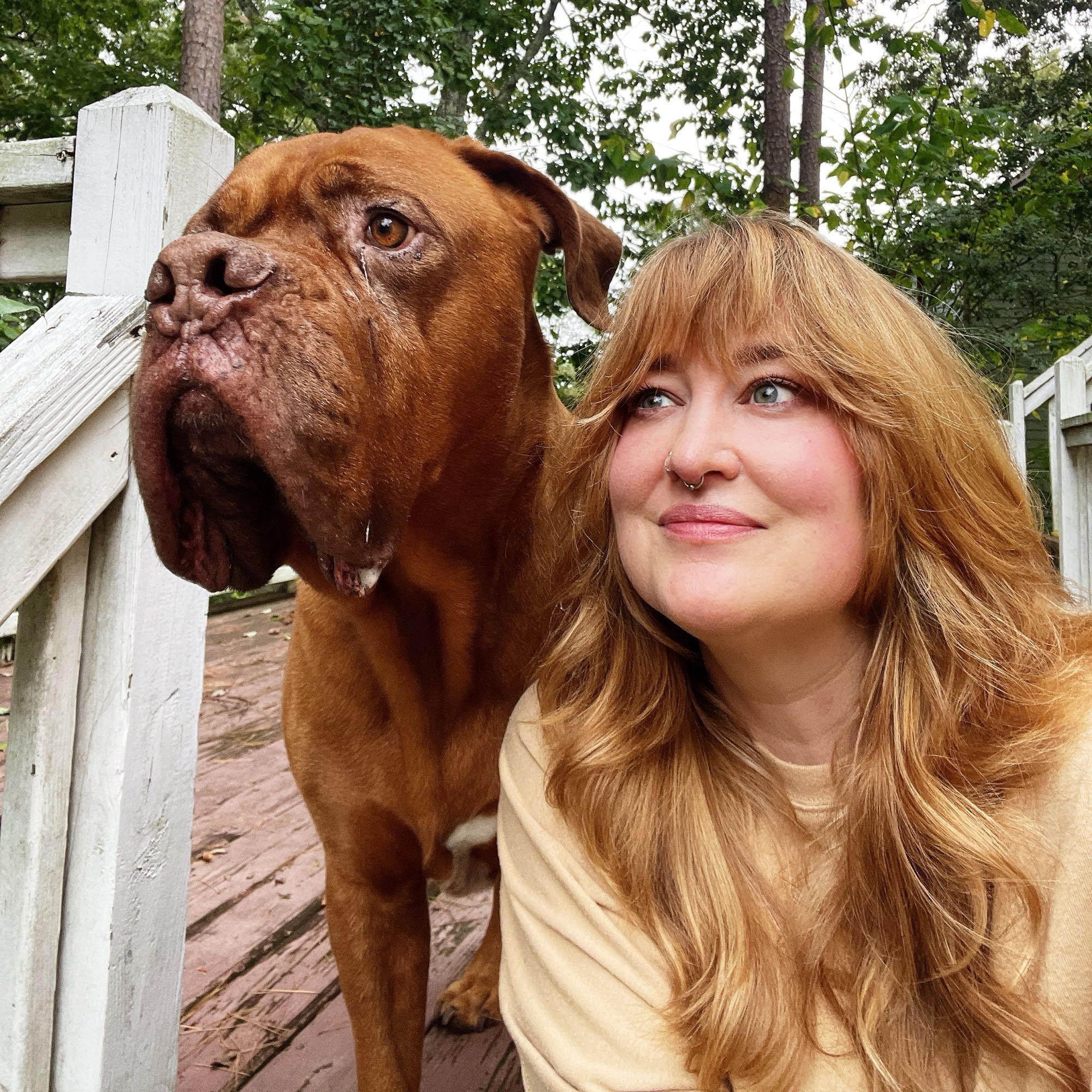 Vanessa and her big red dog, looking off to the side.