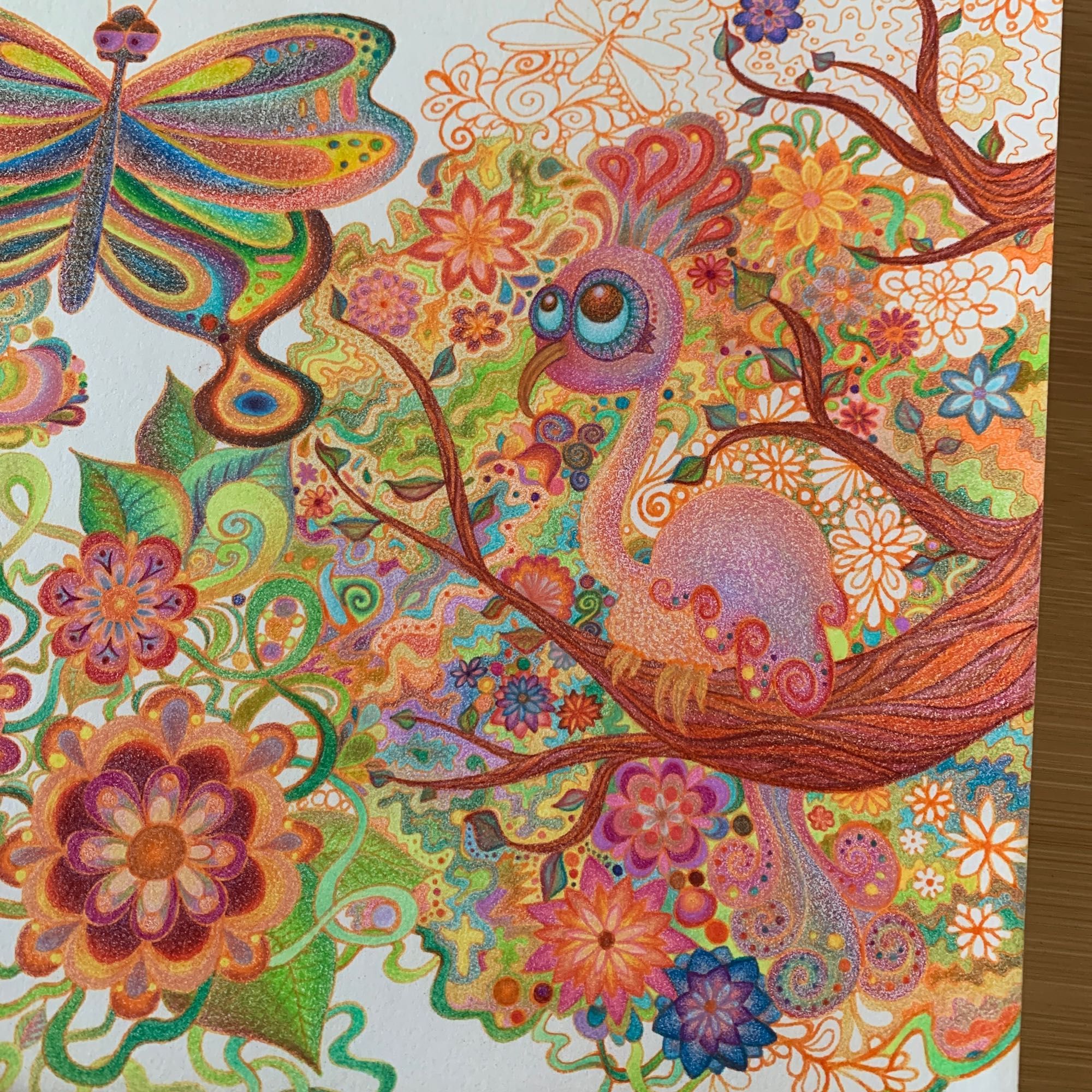 A partially finished colorful pen and colored pencil drawing of a stylized bird on the branch of a flowery tree, with a sassy butterfly flying nearby