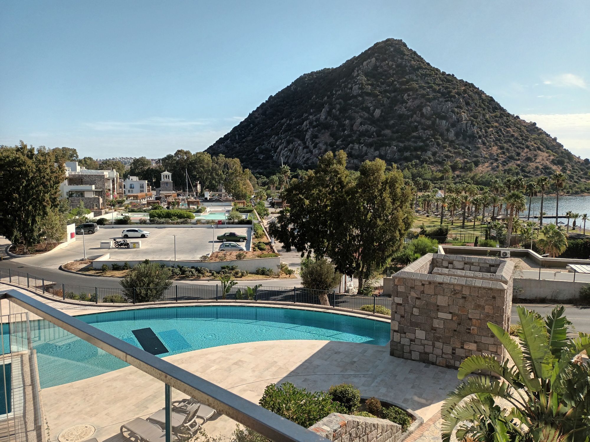 View from conference venue for Bodrum Roundtable, showing blue sky over swimming pool and marina.