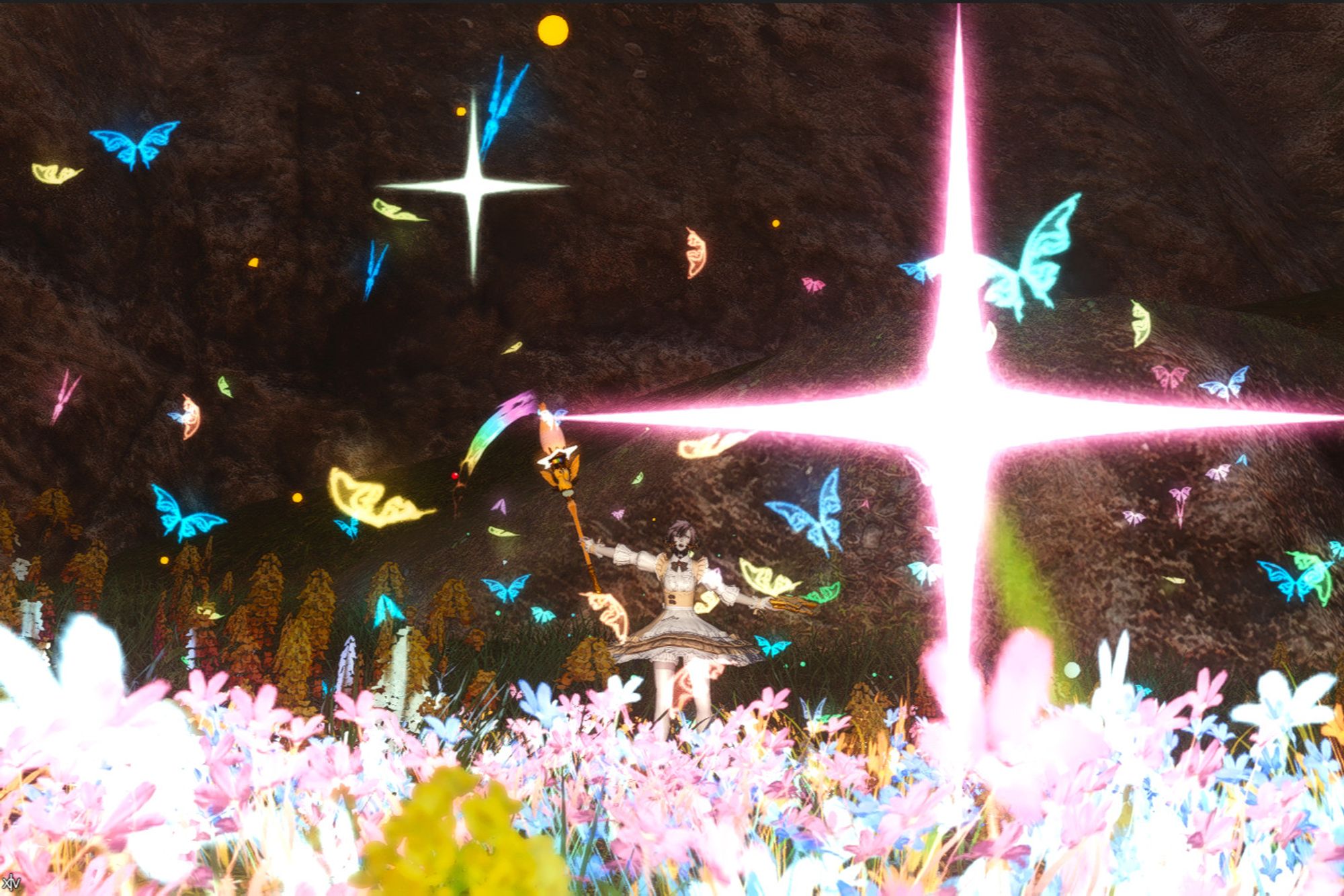 An Au Ra pictomancer casting Rainbow Drip. The flowers before them are glowing pink and blue, there are yellow, pink, green and blue butterflies in the air, and there's glitter in the air. They have a paint palette in their left hand, and a paintbrush in their right.