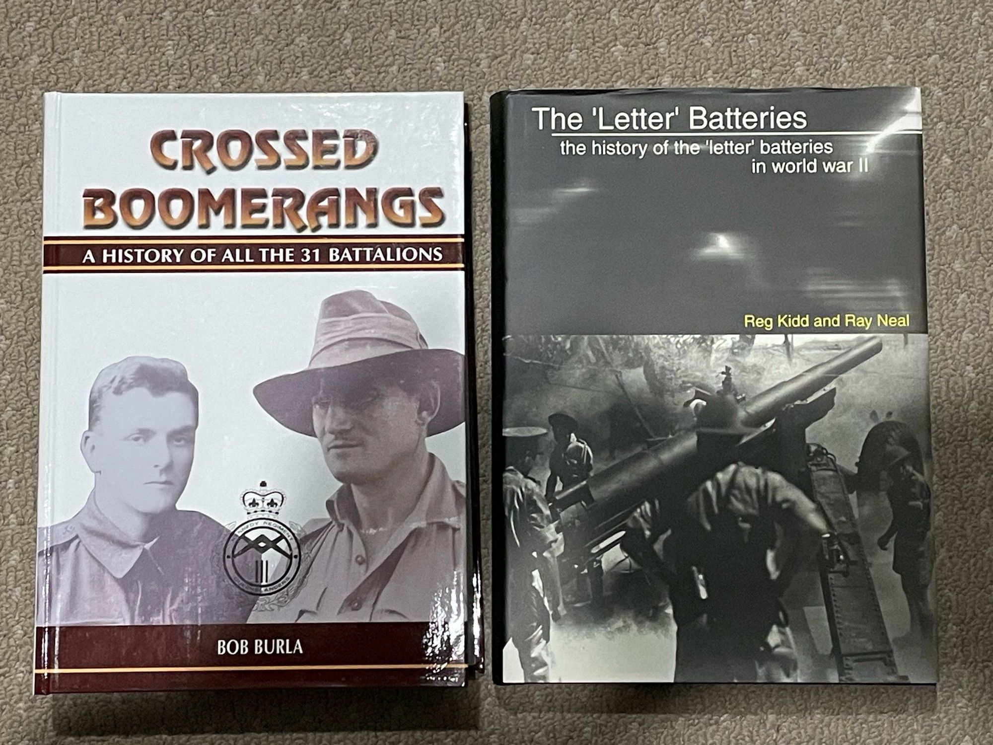 Covers of two hardcover Australian military history books - “Crossed Boomerangs: A history of all the 31st Battalions” and “The ‘Letter’ Batteries- the history of the ‘letter’ batteries in World War II”