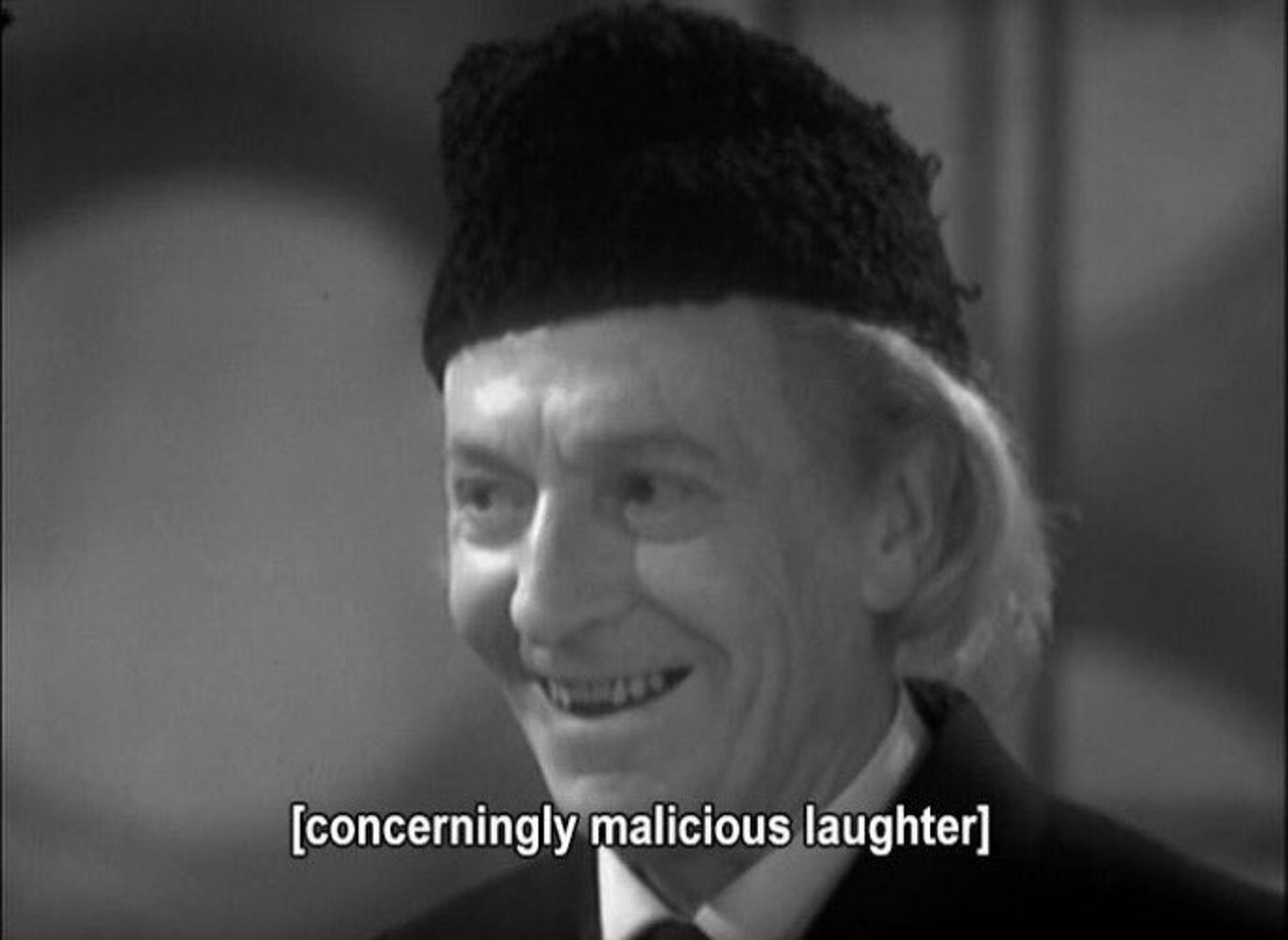 The first Doctor (Doctor Who classic) with a menacing grin and the caption "concerningly malicious laughter '